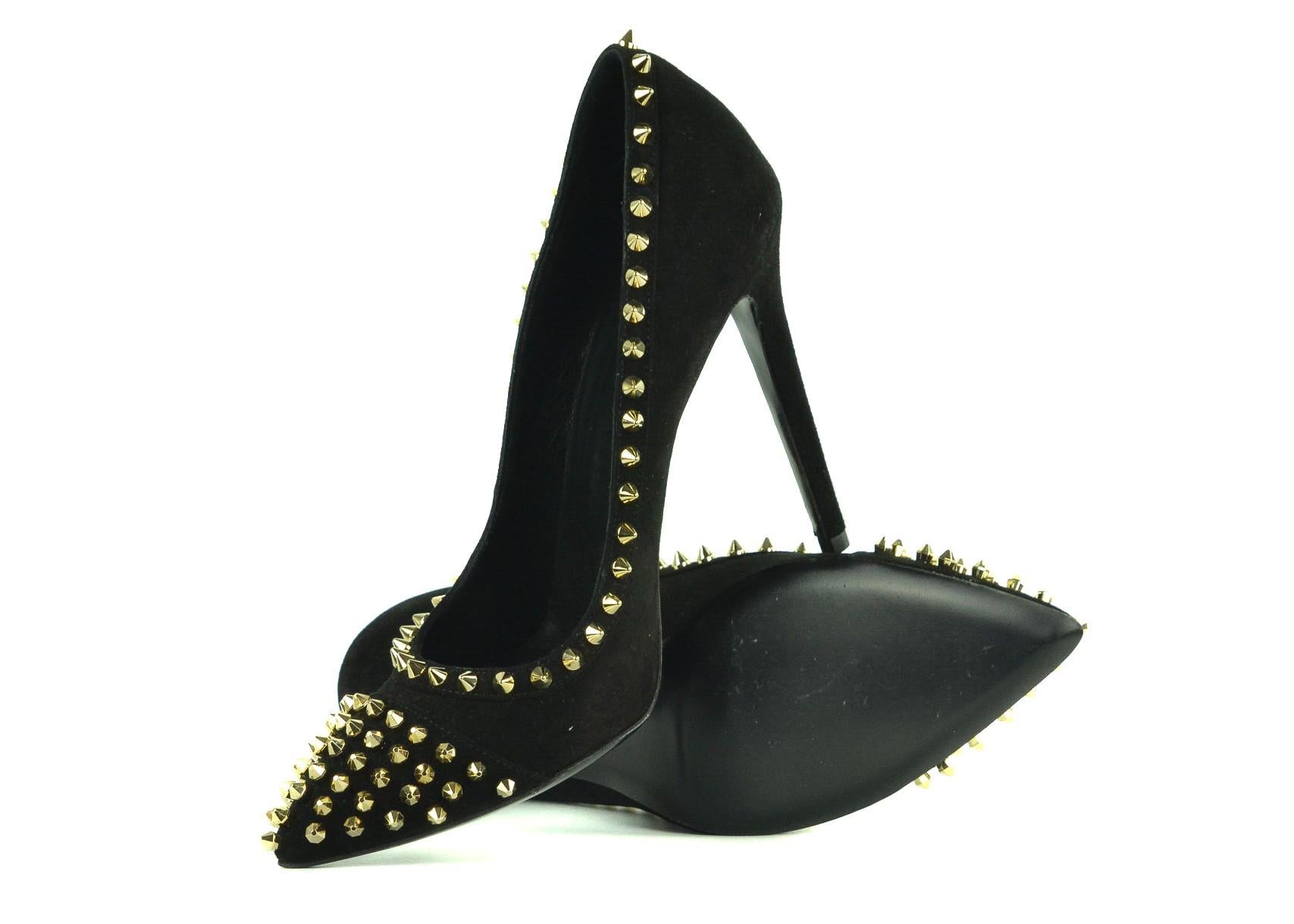 Philipp Plein's Suede Decollate Columbia Pumps will be the silent eye catcher in the room. These supple shoes feature a rich black suede, pointed toe line, and edgy gold spike studded appliques. This pair deals the deal with its Plein branded insole
