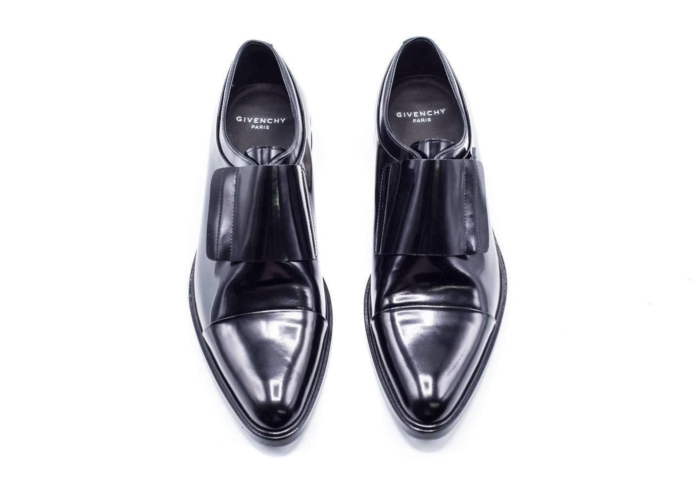 Classic black oxford silhouette from fashion house Givenchy to up your dressy wardrobe. Pair with any dress bottoms and dress shirt for that classic look. Monk Style Strap over With a Hidden Zipper to make this Shoe a classic. Metal Stripe on Heel