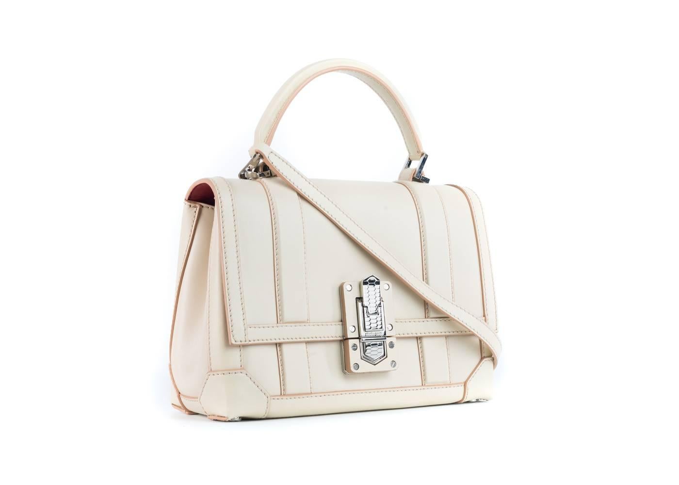 Creme 100% Leather Roberto Cavalli shoulder bag with Silver-tone hardware, With shoulder straps, leather trim, dual exterior pockets with fold-in flap closures,, Silver Clasp to open bag. two tone creme look. Includes tags. Shop Roberto Cavalli