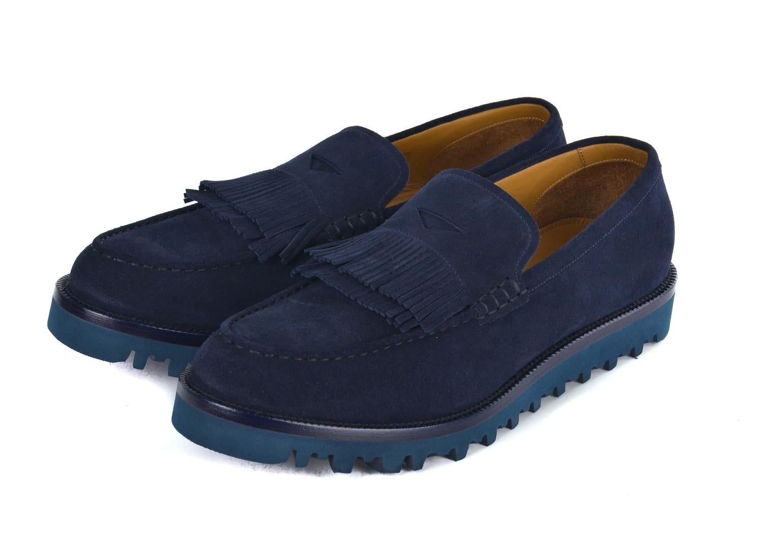 Calmly slip into your regal classics when in your Giorgio Armani Loafers. Known for blending refinement with modern edge Armani's combination of Navy suede, dapper fringing, and modern teal sole will provide the sophistication you need, Add to your