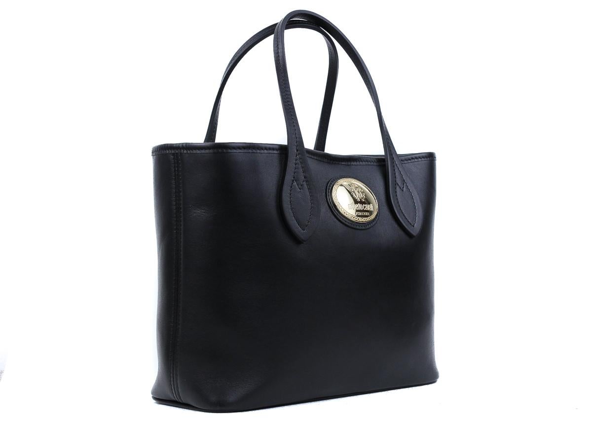 Roberto Cavalli black leather shopping tote bag. This tote bag features a leather textile in a beautiful solid black color tone with contrasting gold tone hardware. This shopping bag is a great accessory for an everyday wear to store all your daily
