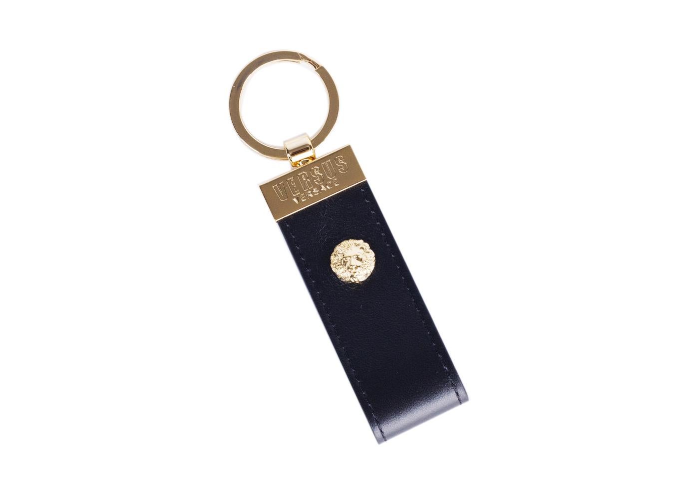 Lock your priorities down in confidence with your Versus Versace Key Ring. This smooth unit features a sleek leather band, miniature gold toned lion head, and clean engraved logo plating. You can hook your essentials onto this for the win and