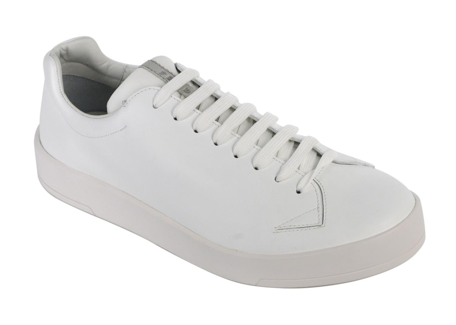 Prada is known for high quality Italian crafted leather all across the world. Add these low top sneakers to your wardrobe and compliment the globe. These sneakers feature pure smooth white leather, tonal low top lace up closure, and smooth