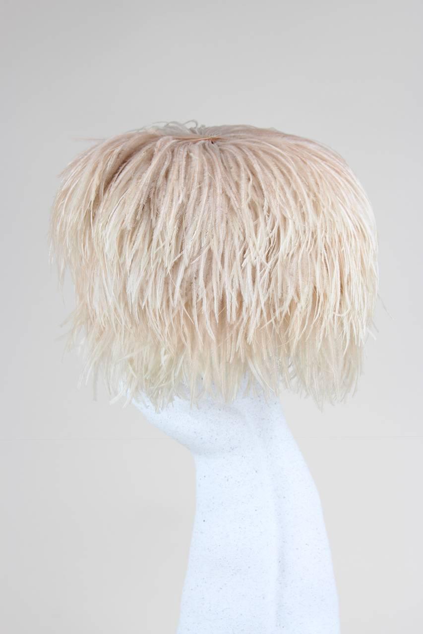 This custom-made light and airy hat has a stiffened tulle base and is richly adorned with frosted pink ostrich feathers. A true conversation piece!

Excellent vintage condition. Hardly worn.

Height of Crown: 14 cm – 5.5