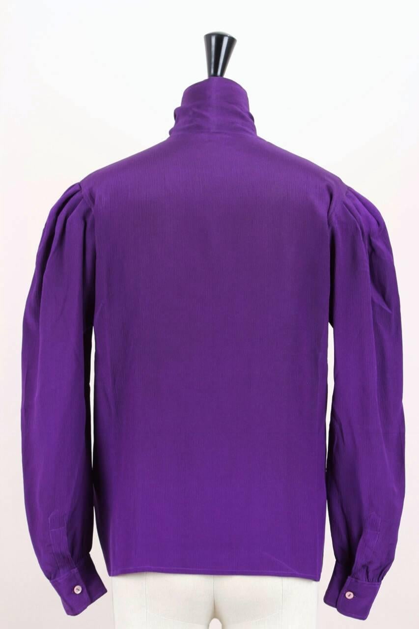 This Yves Saint Laurent blouse has an amazing colour – a deep purple or ultra violet done in a crinkled slightly stretchy silk. There are all the YSL signature touches - the high, gathered shoulder and slightly ruffled cuffs and the high neck with