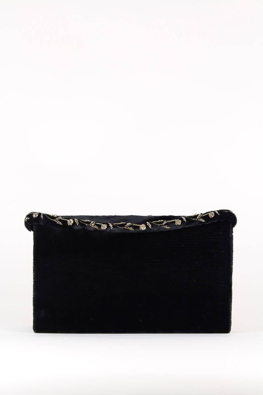 This outstanding black silk velvet evening bag is decorated with a rich 3D quality Zardozi embroidery on the front flap featuring a prancing peacock in the center surrounded by a floral design. It is probably made in India as peacocks are the