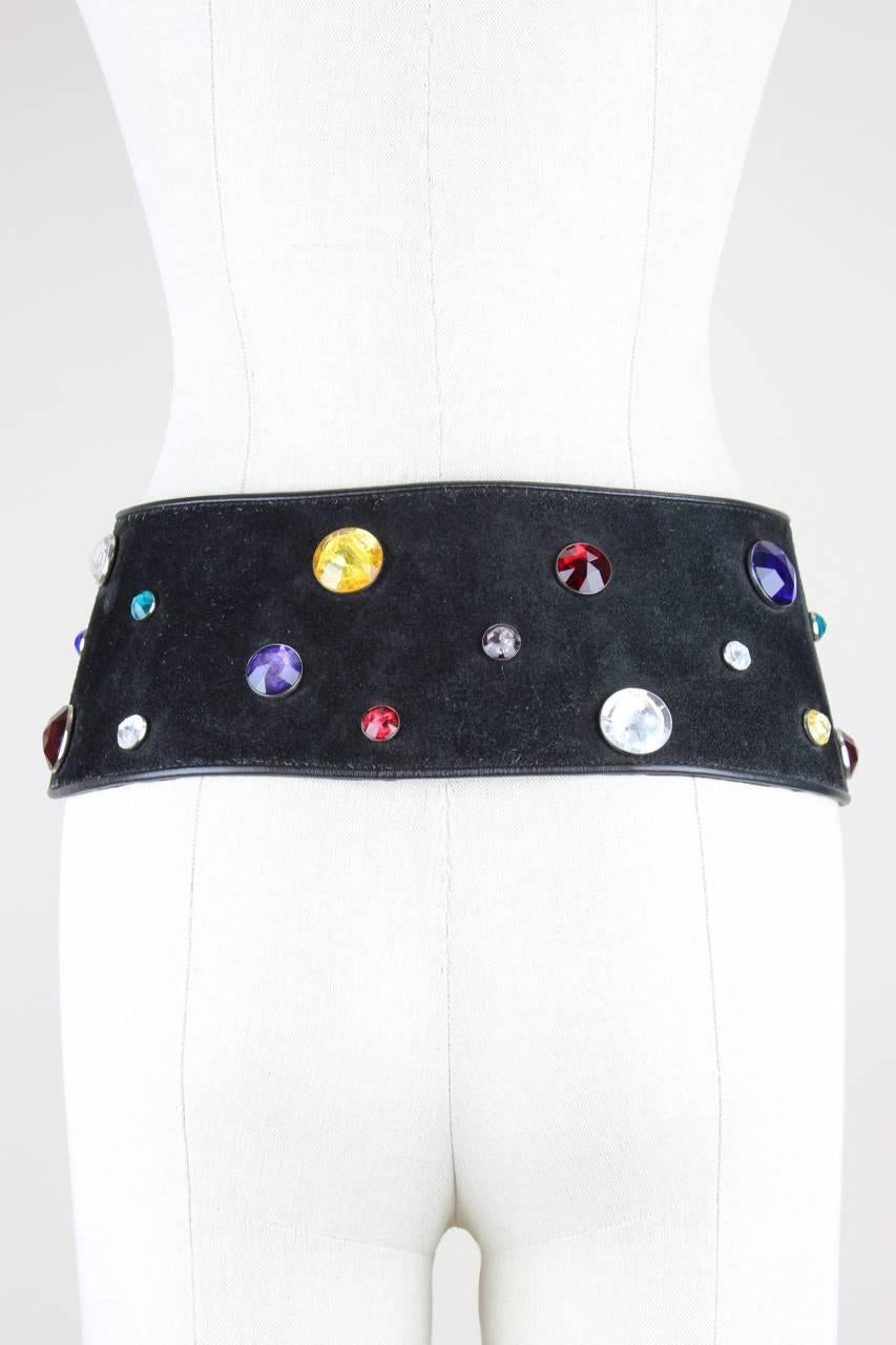 This wide slightly curved belt is crafted from black suede with a smooth leather trim and is embellished with multi-coloured jewel rhinestones in variable sizes. It features a dark silver-toned double D-ring buckle, is lined in black leather and