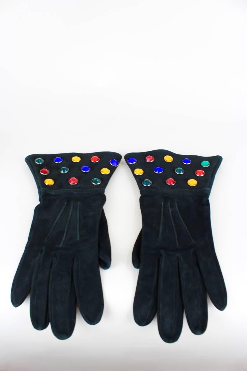 These gloves are made from black supple suede and are adorned with multi-coloured jewel rhinestones on the cuffs. They are unlined, stamped  "Saint Laurent rive gauche Made in France" on the interior and belong to a set comprised of the