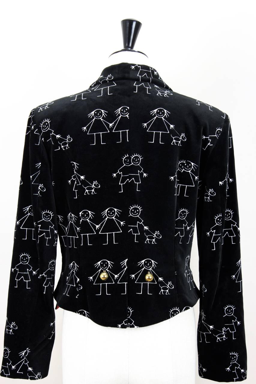 This blazer is made from black cotton velvet. The white stick man print shows girls and boys, some of them walking a dog. The jacket features notched lapels, long sleeves, padded shoulders and two bright red lined flap false pockets on both sides –