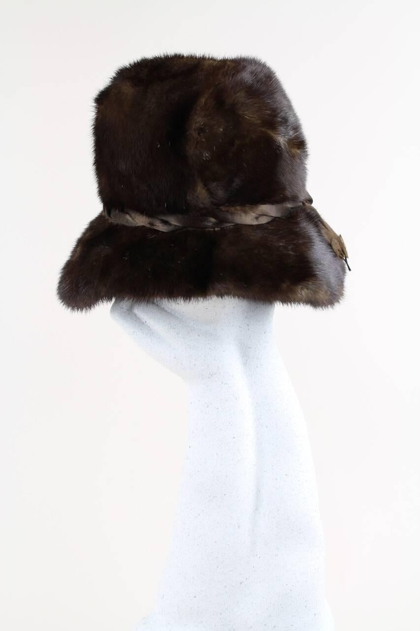 This enchanting 1960s brimmed mink fur hat is designed with lustrous dark chocolate brown real mink fur. Love the effect of the slightly wider brim at the front that gives the hat that certain something! The hat is embellished with a