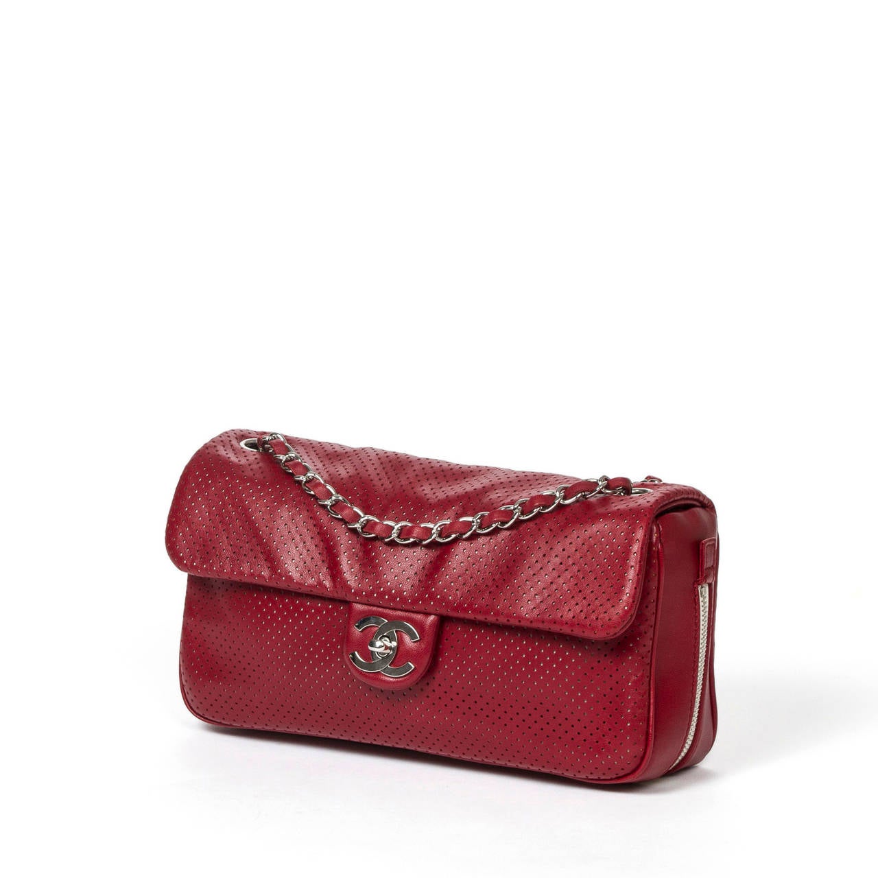 Limited Edition Burgundy perforated leather expandable flap bag with CC turnlock, silver tone hardware. Double chain strap interlaced with burgundy leather. White fabric lining with 1 zip pocket. Box, dustbag and authenticity card included.