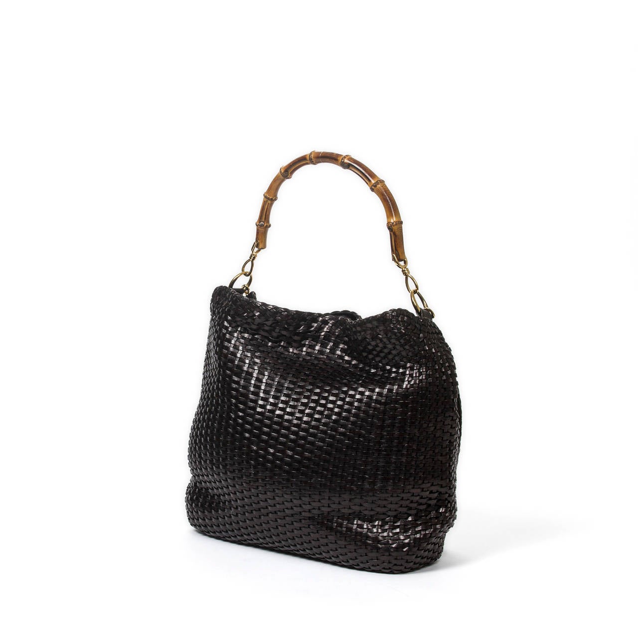 Handbag in black woven leather with bamboo handle with braided strap, gold tone hardware. Black suede interior with zip pocket. Few scuffs on the leather, Perfect condition.