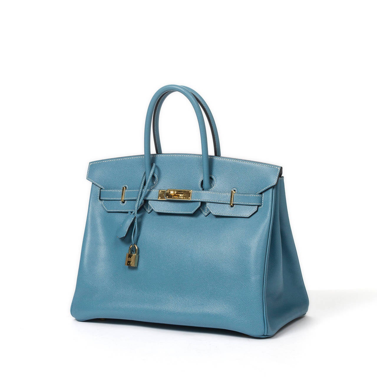 Birkin 35 in epsom blue jean with cadenas and keys in clochette, gold tone hardware. Stamp F in square (2002). Dustbag included. Very slight scuffs on the hardware, perfect condition.