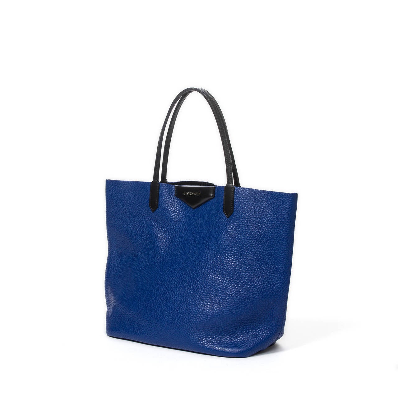 Tote bag in electric blue grained leather with black straps. Black coated leather interior with blue electric leather pouch. Dustbag included. Mint condition.