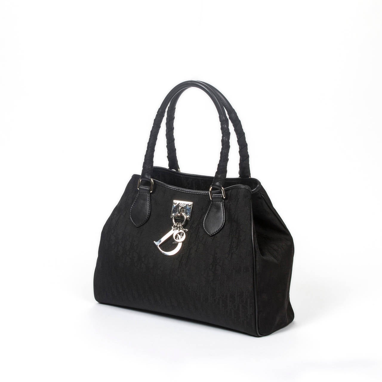 Dior Vintage handbag in black monogram canvas. Handles in black leather. Silver tone hardware with Dior in silver letters charm. Lined interior in black canvas with one zip pockets and 2 slip pockets. Perfect condition.