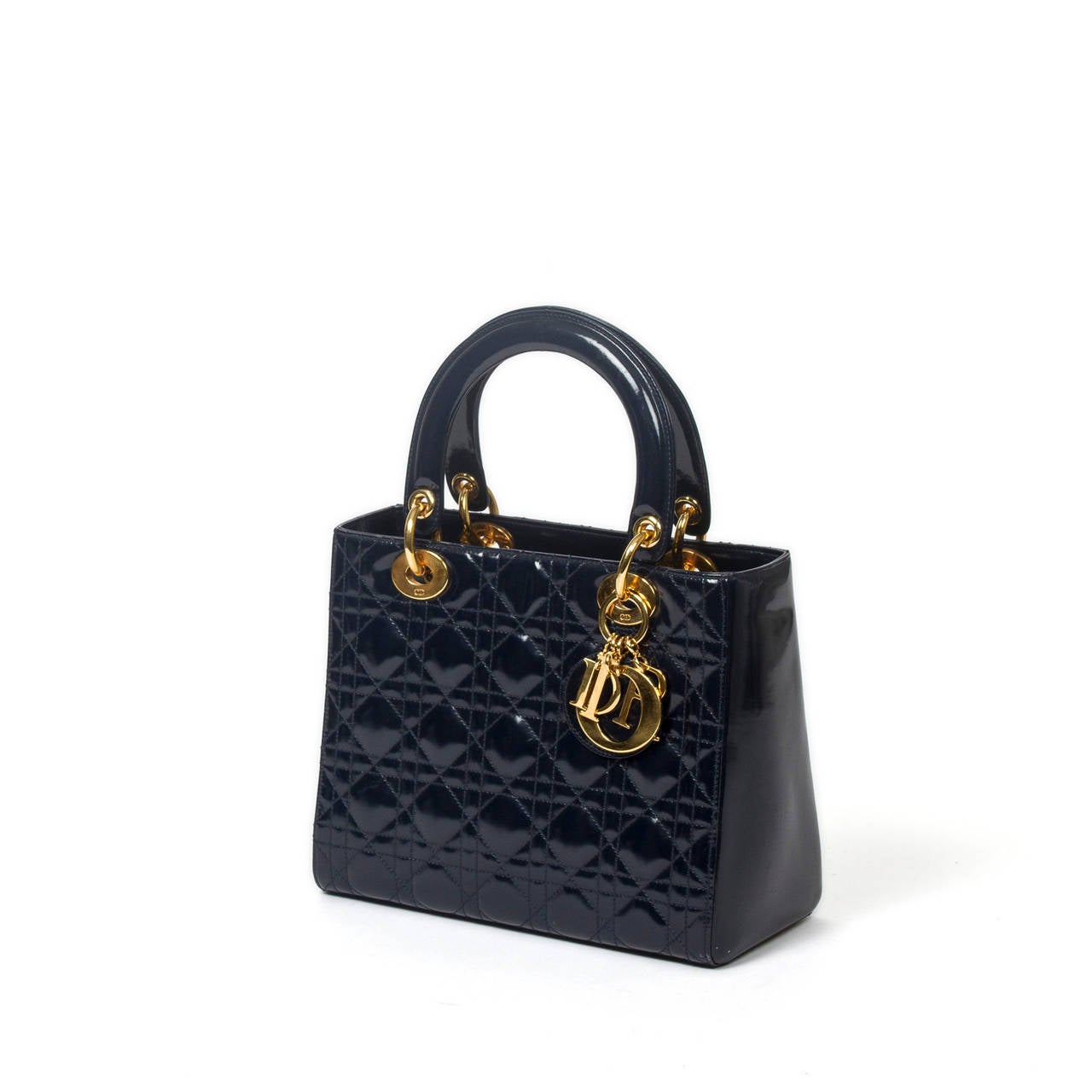 Lady MM in navy color cannage patent leather with shoulder strap and gold tone charms. Black jacquard canvas lined interior with zip pocket. Dustbag included. Few marks on the leather at the handles. Excellent condition overall.