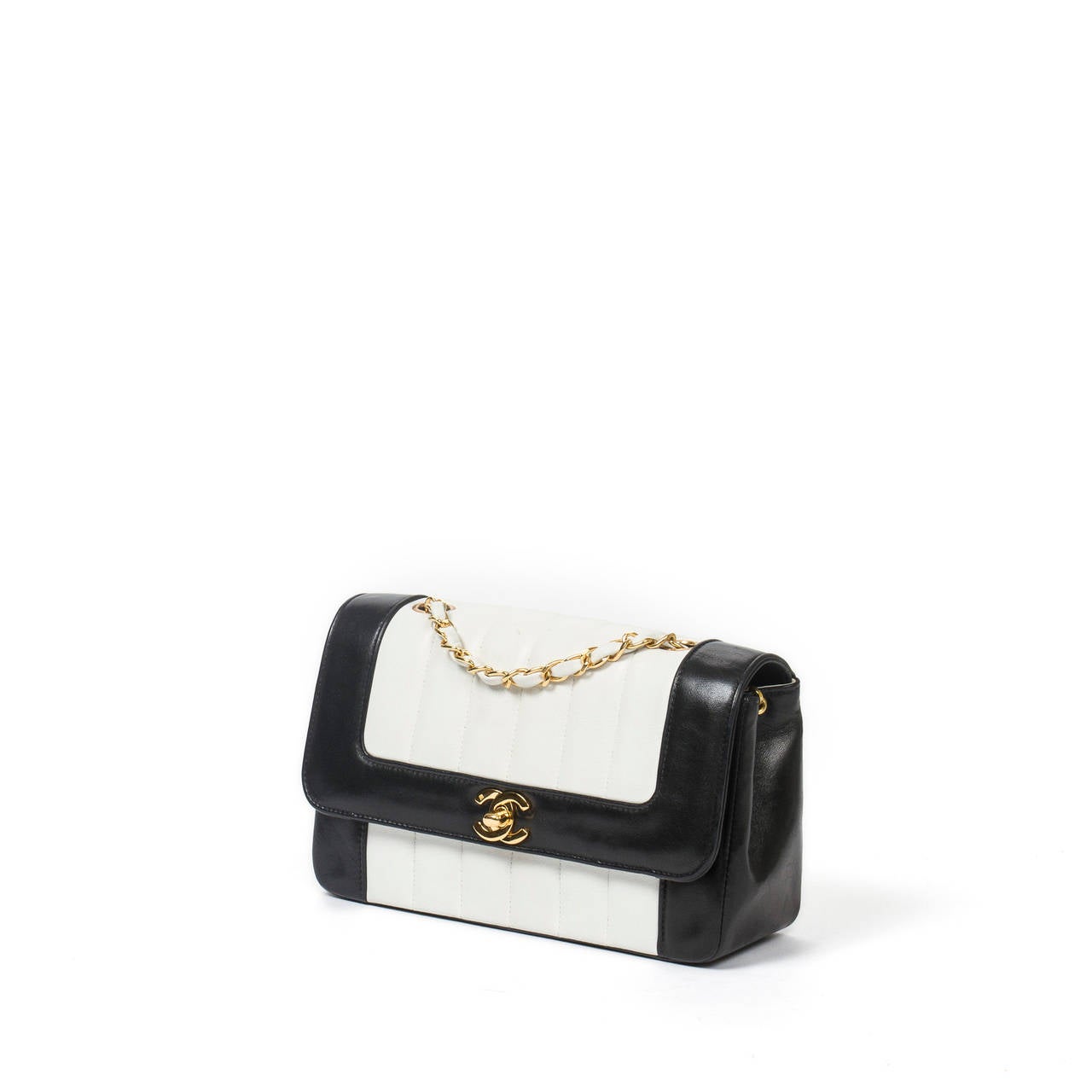Chanel Vintage classic flap in black and white leather. Simple chain interlaced with white leather. Gold tone hardware. 
