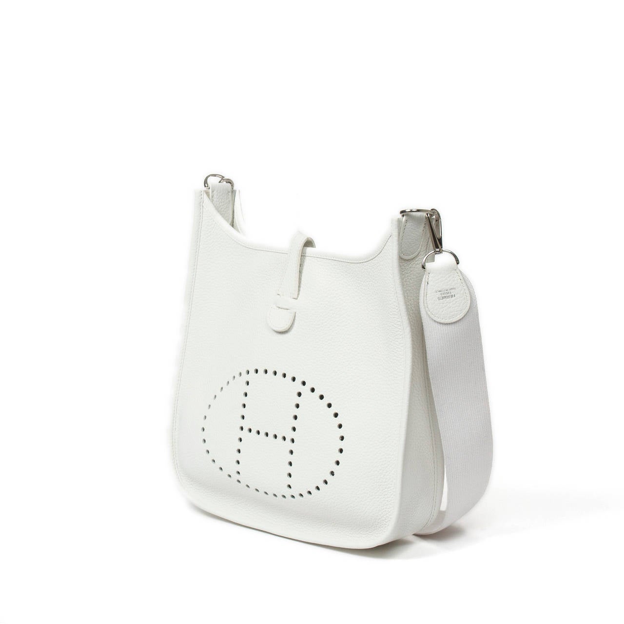 Hermès Evelyne 2 PM in white taurillon leather. Strap adjustable in white canvas. Silver tone hardware. Stamp R in square (2014). Box, dustbag included. Pristine condition.