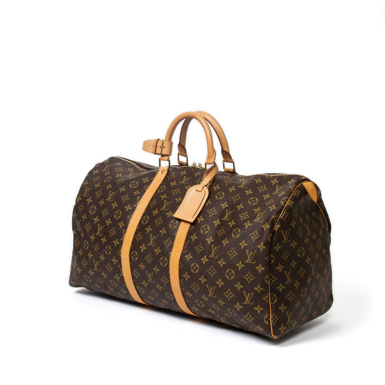 Louis Vuitton Keepall 55 in monogram canvas with vachetta leather handles, luggage tag, handle strap, cadenas and keys, golden brass hardware. Brown canvas lined interior. Date code FL0929. Beautiful patina on the leather, pristine condition.