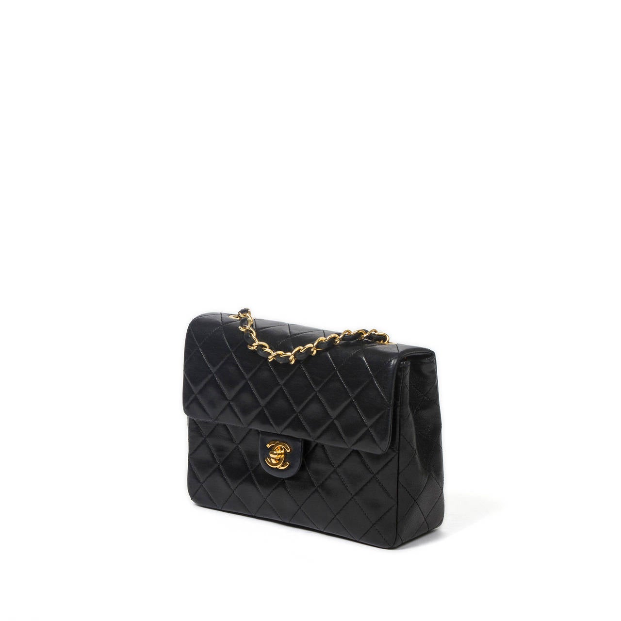 Chanel Mini classic single flap in black quilted leather. Chain strap intrelaced with black leather. Lined interior in burgundy leather with one zip pocket and one slip pocket. Gold tone hardware with 