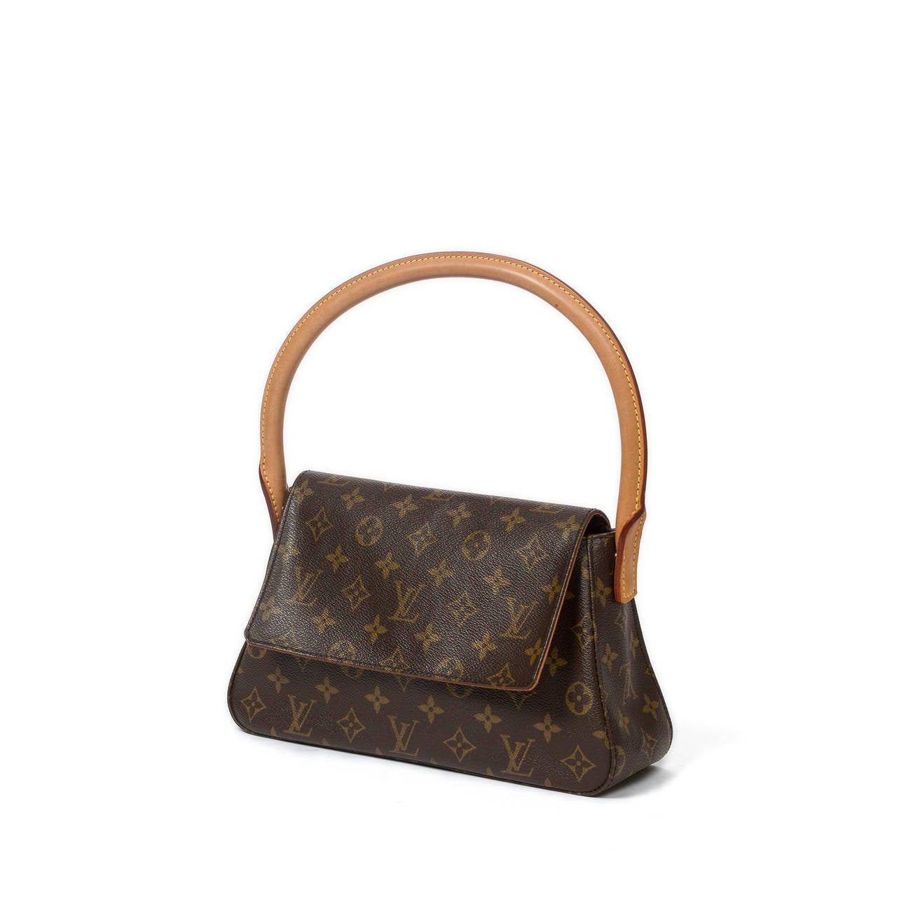 Louis Vuitton Mini Looping in monogram canvas with vachetta leather handle, magnetic closure. Brown canvas lined interior with zip pocket. Model of 2001. Production code : MI1011. Dustbag included. Very nice patina on the leather. Perfect condition.