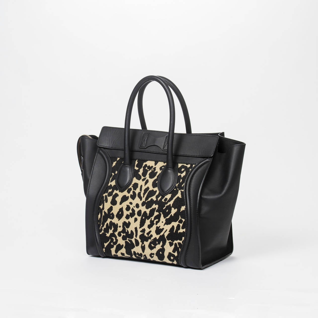 Luggage GM in leopard print canvas with black leather handles, gold tone hardware.