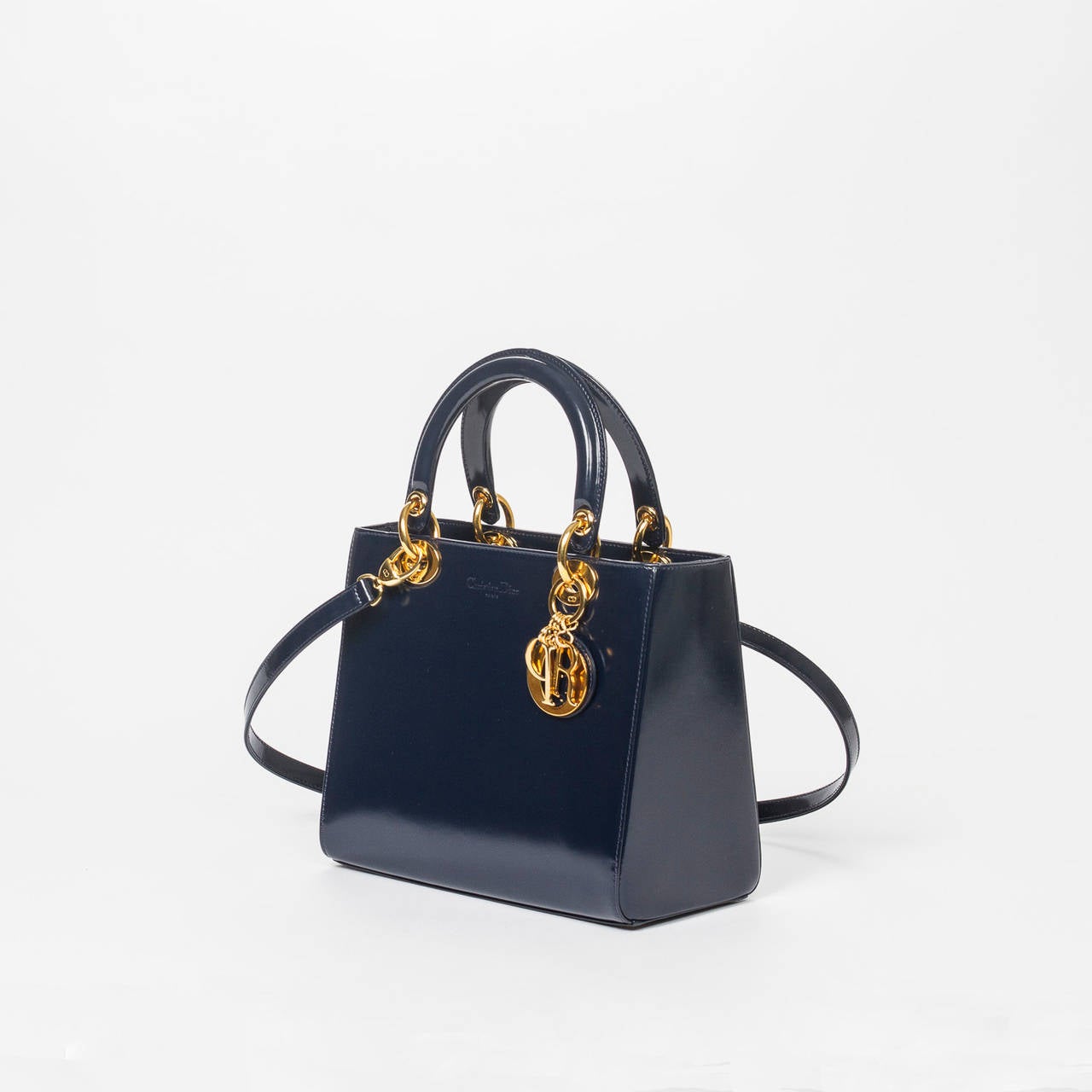 Lady PM in navy cuir glace with shoulder strap, gold tone hardware.