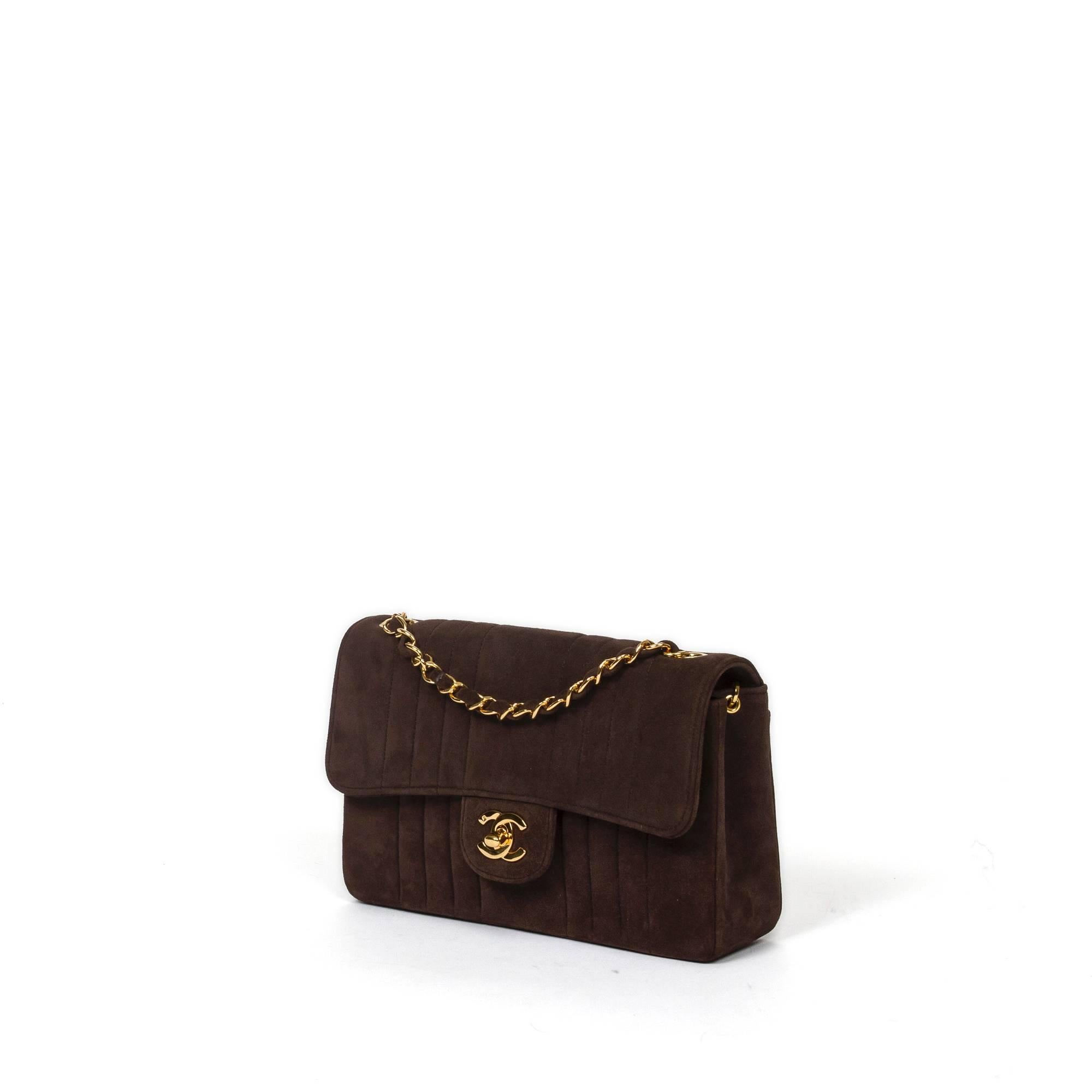 Chanel Vintage Classic Single Flap 23cm in chocolate brown vertical quilt nubuck with single chain strap interlaced with brown nubuck (drop 51cm). Gold tone CC turnlock and hardware. Brown leather interior with one slip pocket and one zip pocket.