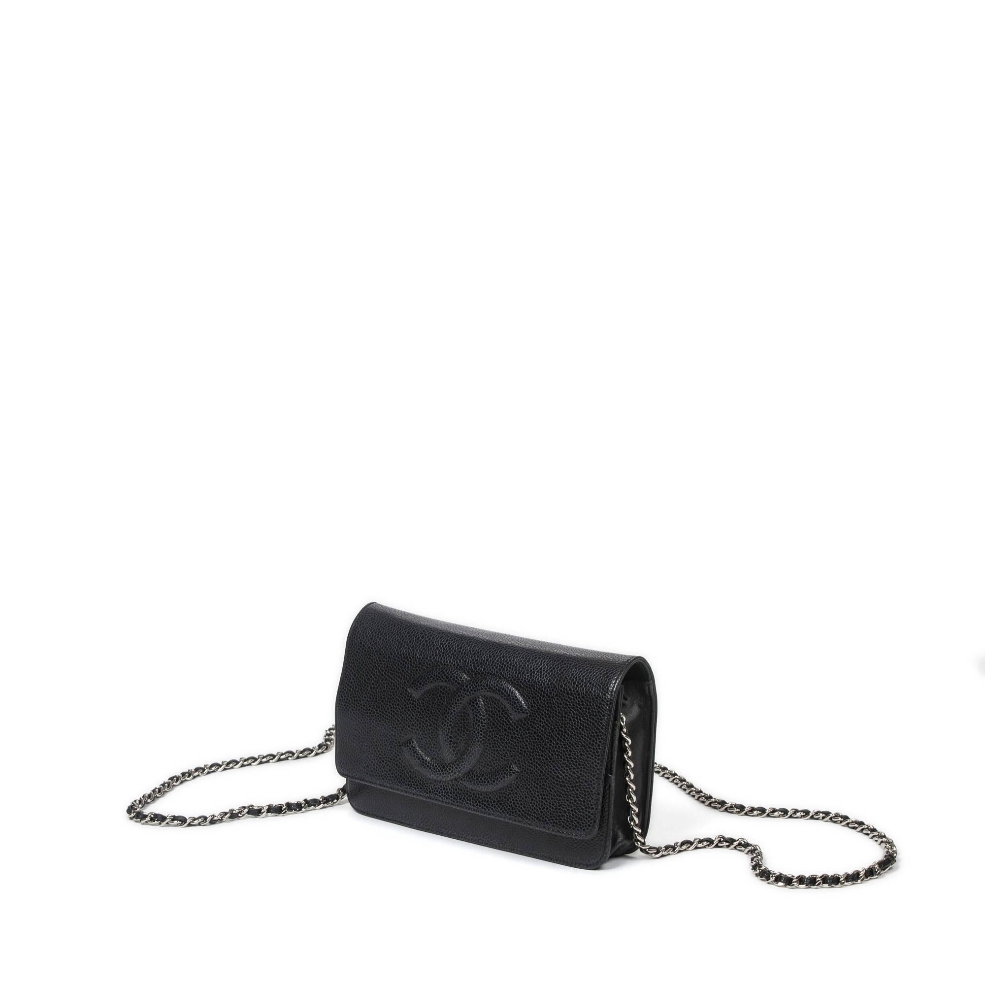 Chanel Caviar Timeless CC Wallet On Chain 19cm in black grained leather with long chain strap interlaced with black leather (60cm), silver tone hardware. Snap button closure. Black canvas lined interior with 2 zip pockets, 2 slip pockets and 6 card