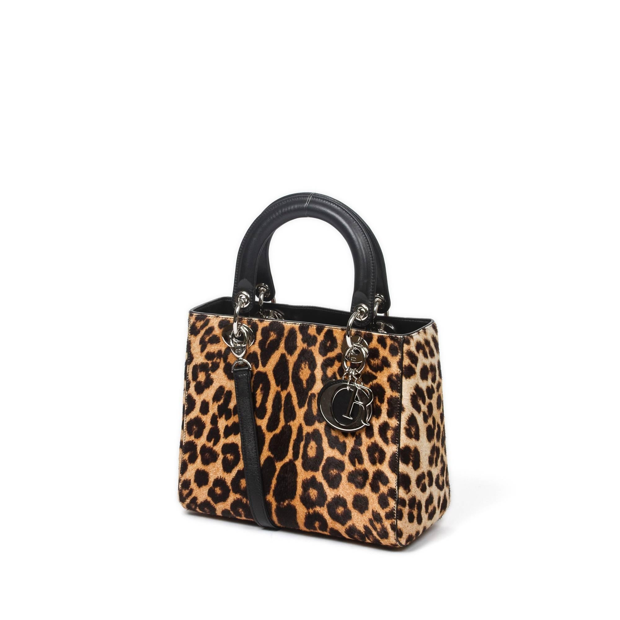 Dior Lady Dior MM 24cm in leopard print pony hair with black leather handles (10cm) and shoulder strap (43cm). Silver tone hardware. Top zipper closure. Black leather lined interior with one zipper pocket. Dustbag included. Production Code