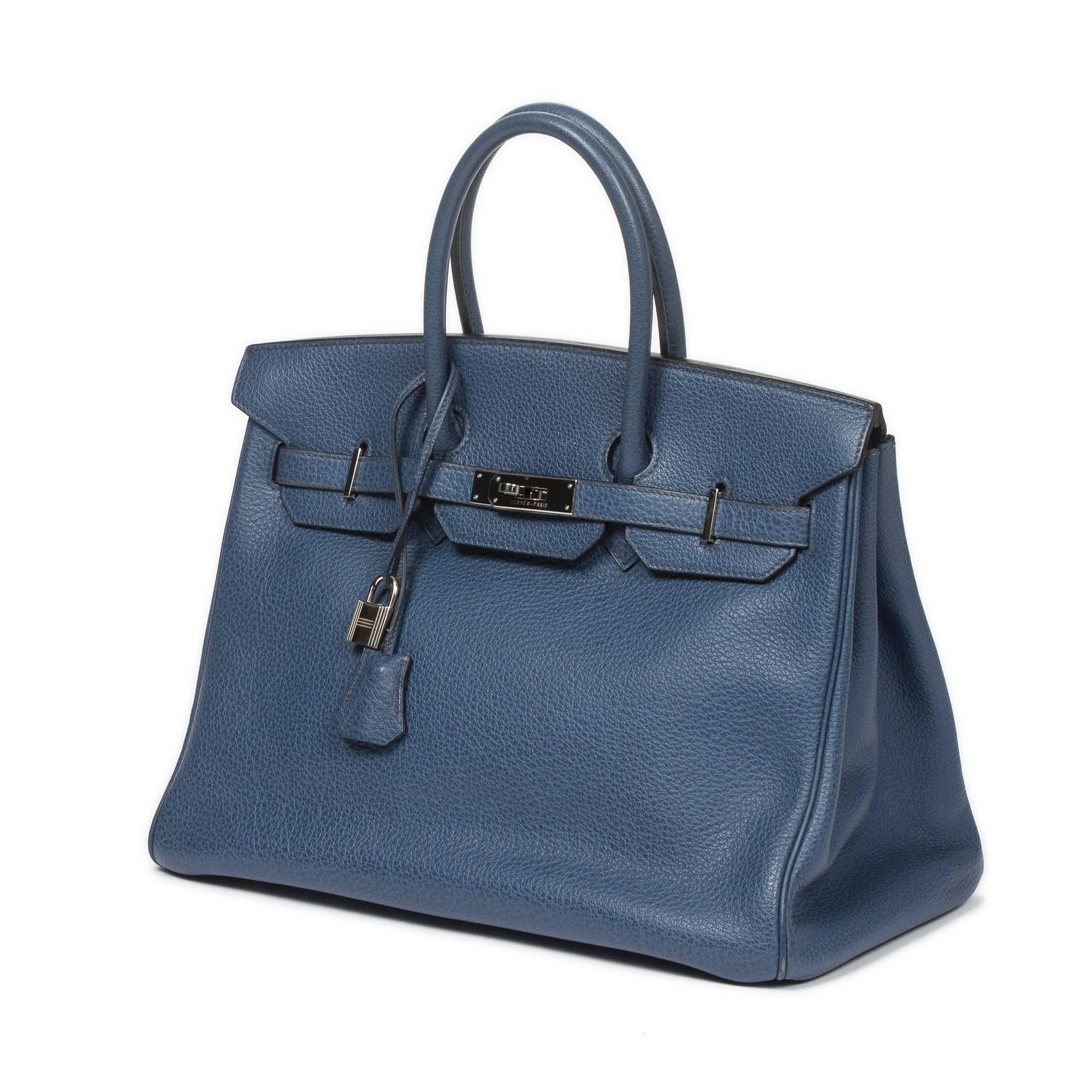 Birkin 35 in blue Buffalo leather with cadenas and keys in clochette, silver tone hardware. Blue Buffalo leather lined interior with one slip pocket and one zip pocket. Stamp I in square. Model from 2005. There are scuffs on the corners, few white