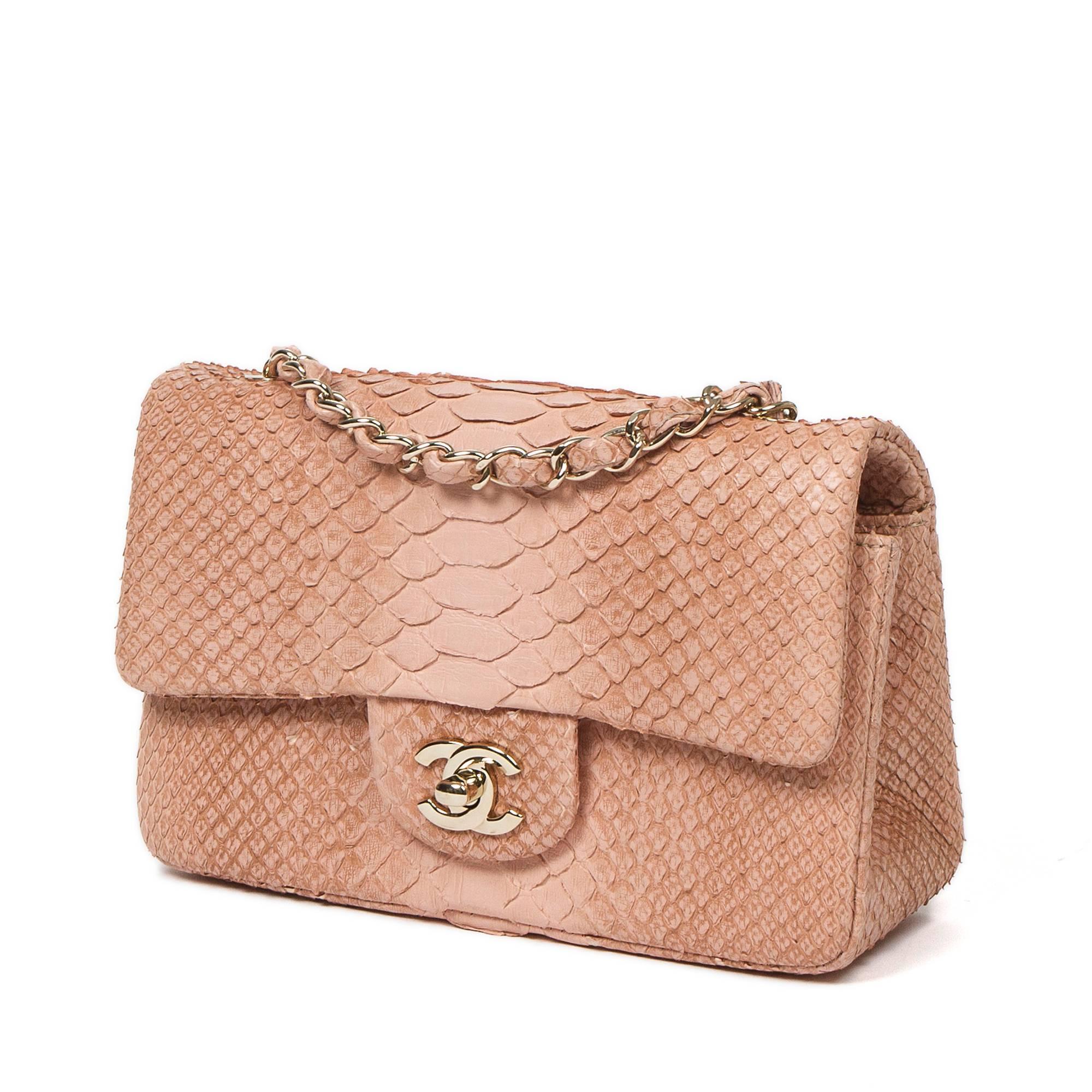 Mini Flap Bag in soft pink python skin, long chain strap interlaced with python skin and signature CC turlock, champaign gold hardware. Back slip pocket. Tan leather lined interior with one slip pocket and zip pocket. Metal plaque signed 