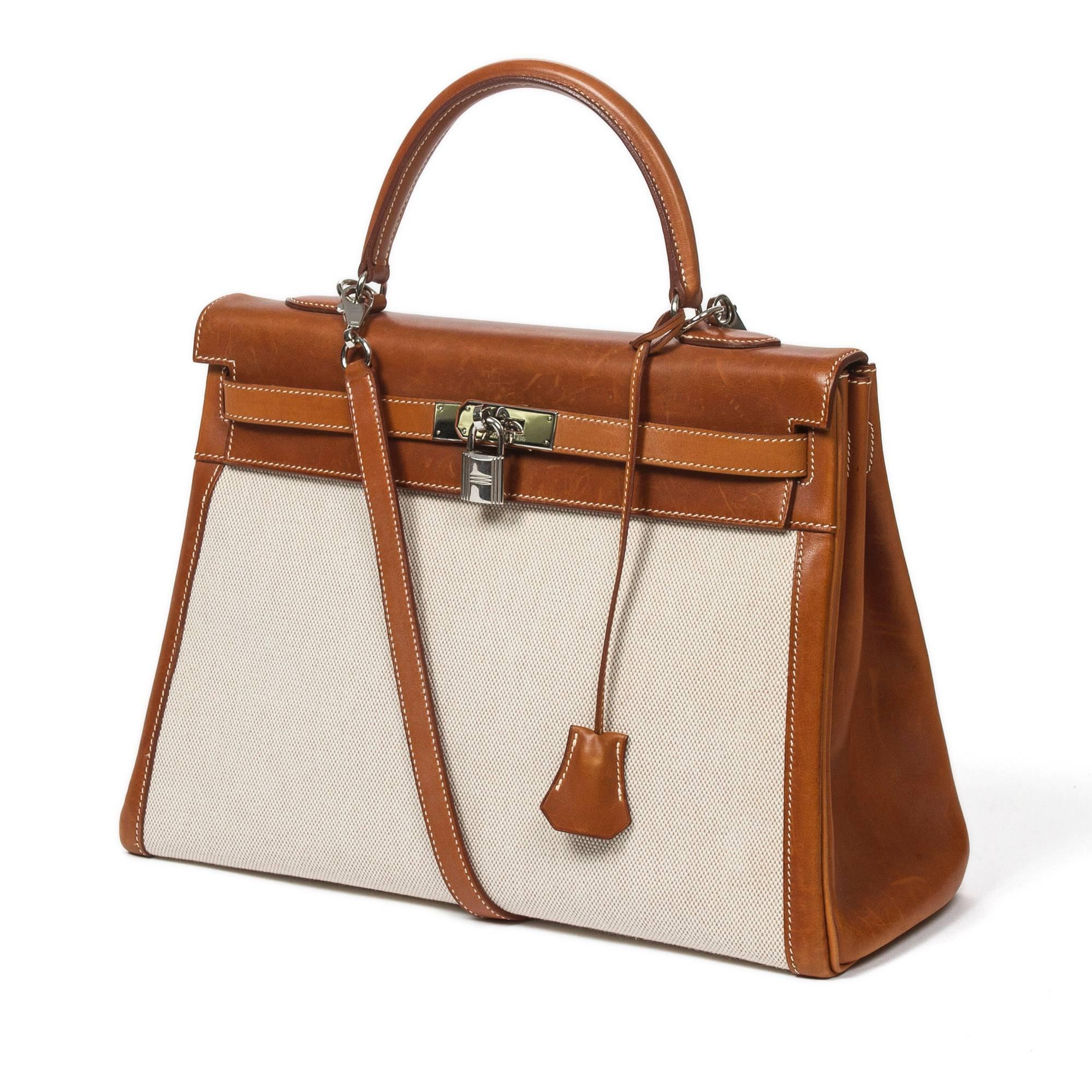 Kelly Retourné 35 in beige Toile H with Barenia leather handle, shoulder strap and accents, cadenas and keys in clochette, silver tone hardware. Interior lined in brown chèvre leather with 2 slip pockets and one zip pocket. Stamp E in square.