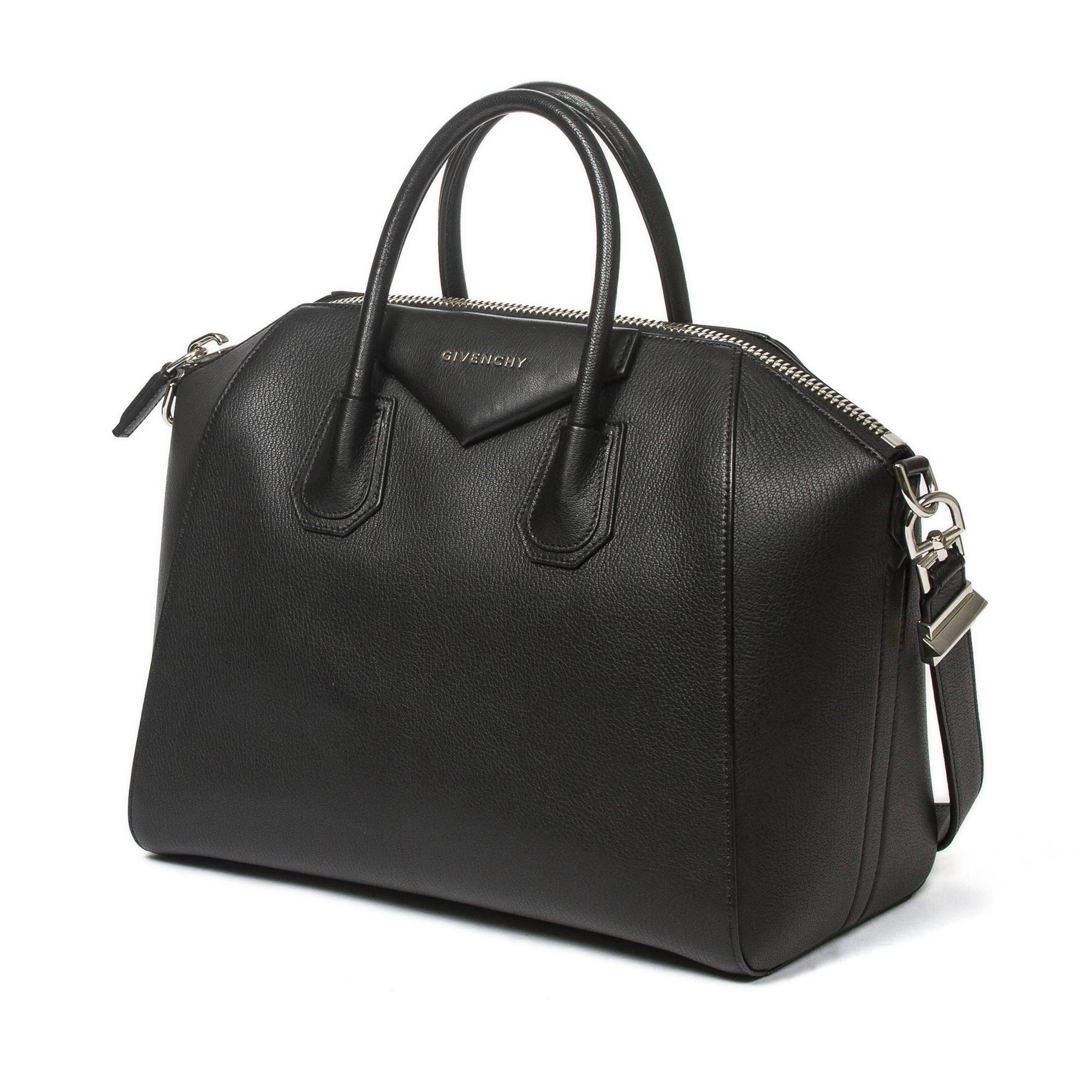 Antigona Medium in black grained leather with shoulder strap and silver tone hardware. Zip closure. Black fabric lined interior with 2 slip pockets and one zip pocket. Production number 3C0163. Dustbag included. This item has been used just a couple