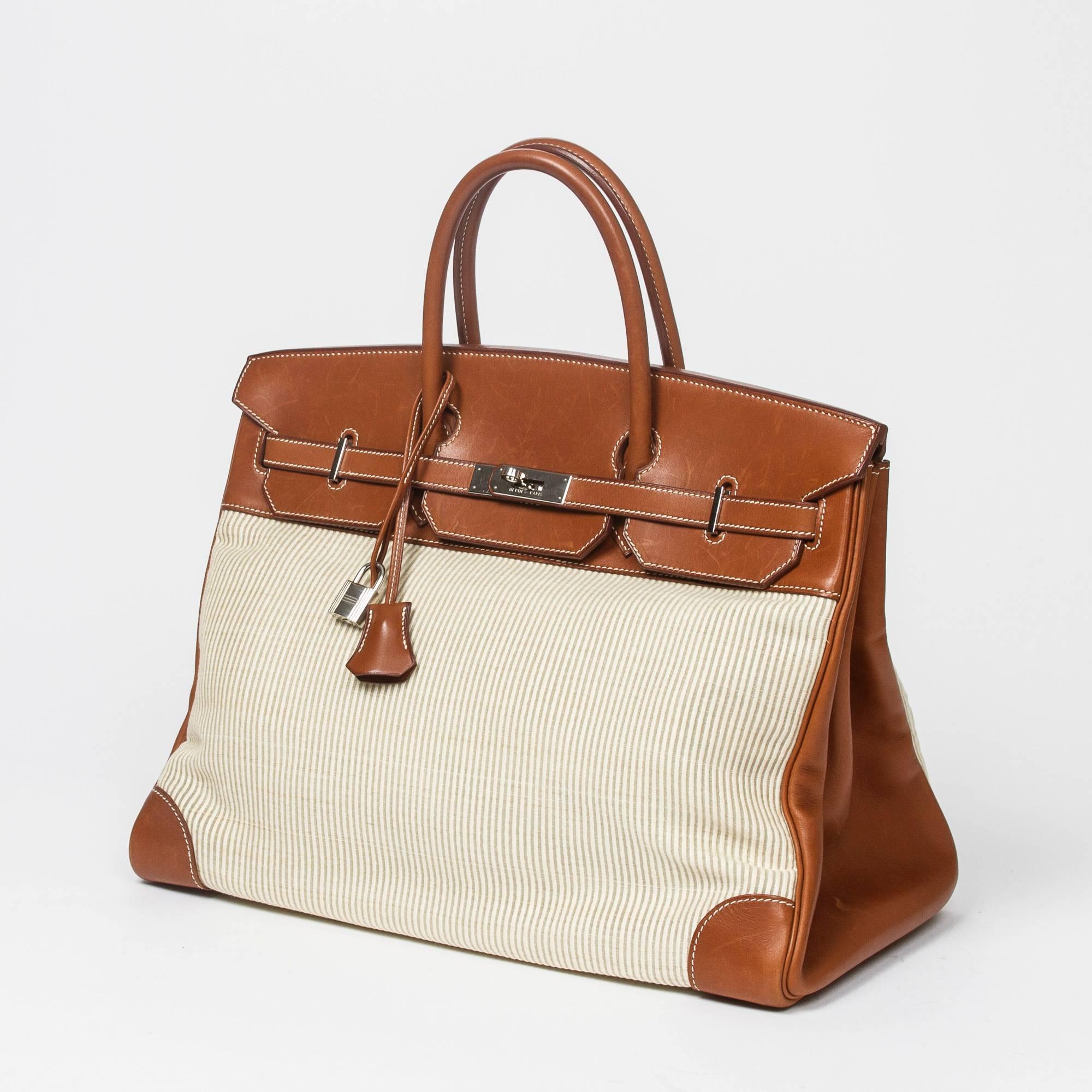 Birkin 40 in ivory Crinolin with Barenia leather handles and details, contasting white stichings, cadenas and keys in clochette, silver tone hardware. Barenia leather and beige chevron fabric lined interior with 2 slip pockets. Dustbag included.