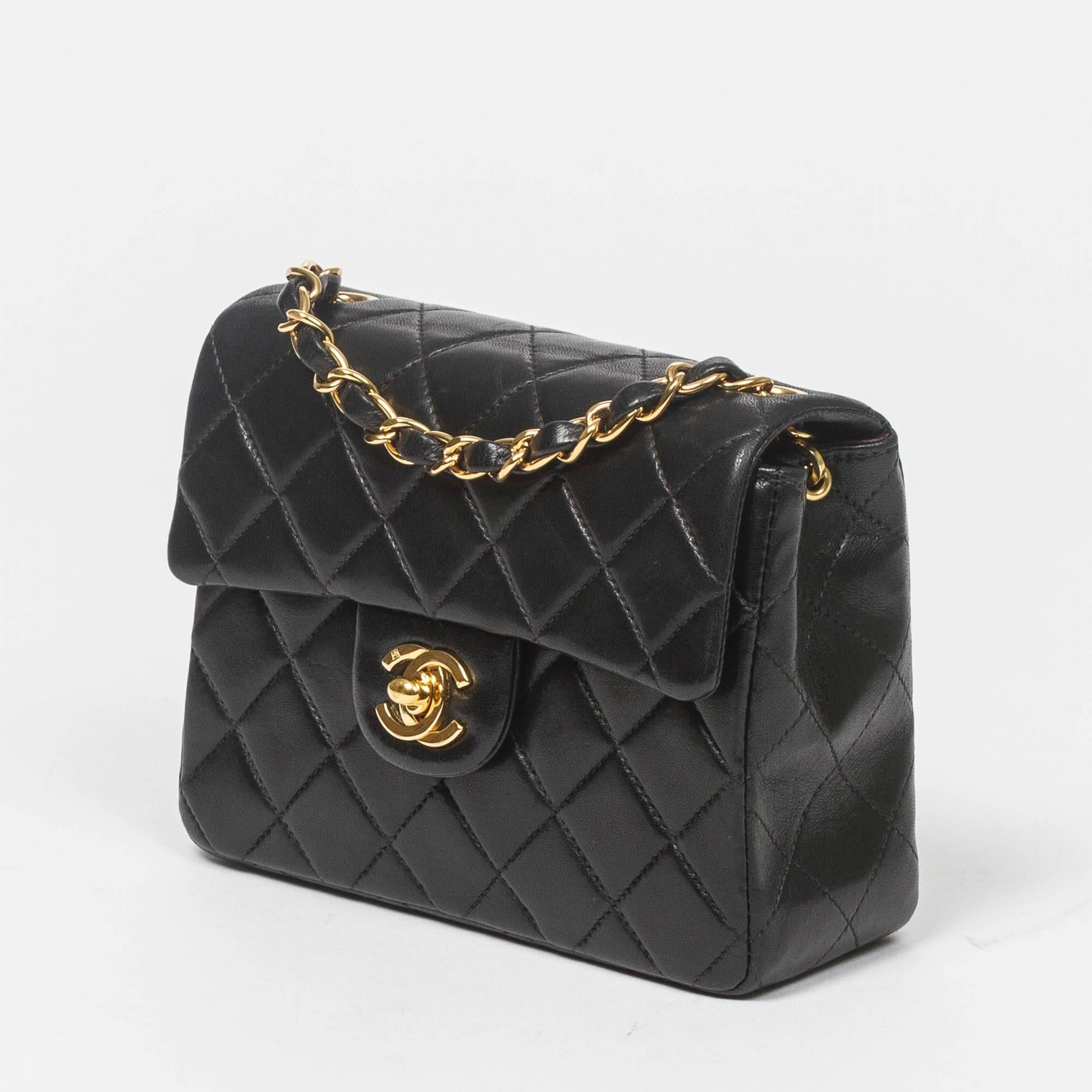 Classic Mini Flap in black quilted lambskin with chain strap interlaced with leather, gold tone CC turnlock. Back slip pocket. Burgundy leather lined interior with one slip and one zip pocket. Gold tone 