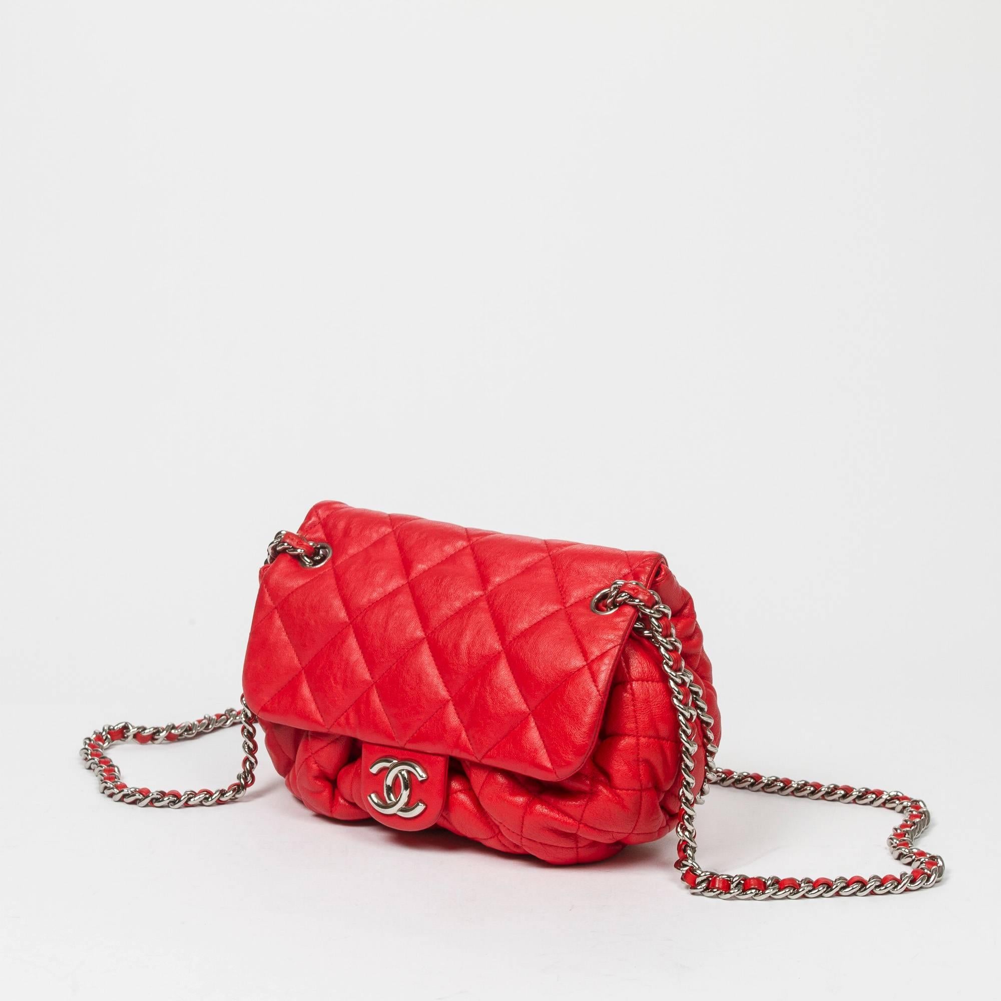 Chain Around Messenger in red quilted leather with long chain strap interlaced with red leather, sliver tone hardware. CC magnetic closure. Beige fabric lined interior with one zip pocket. Silver tone heat stamp 