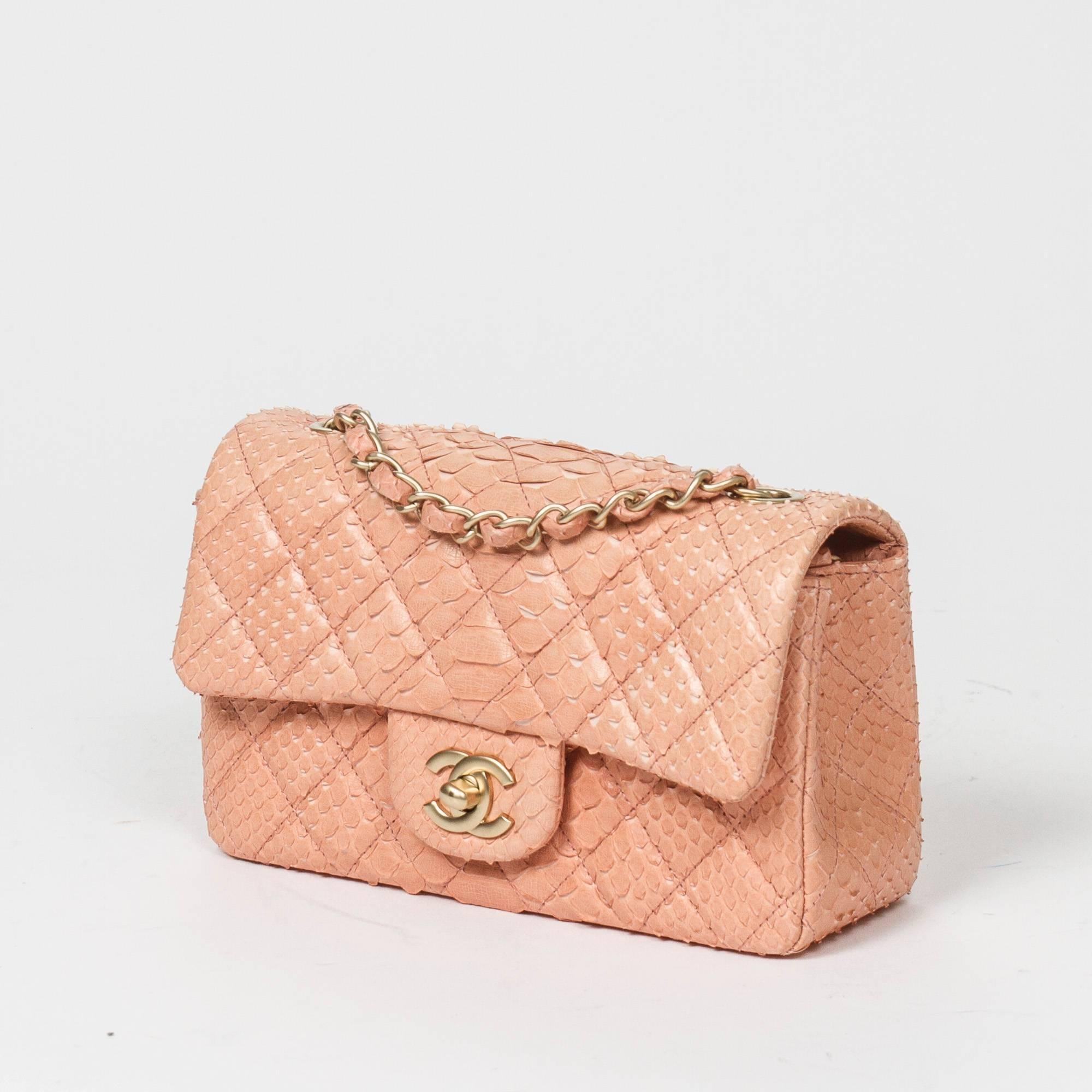 Mini Flap Bag in soft pink python skin, long chain strap interlaced with python skin and signature CC turlock, brushed champaign gold hardware. Back slip pocket. Light pink leather lined interior with one slip pocket and zip pocket. Metal plaque