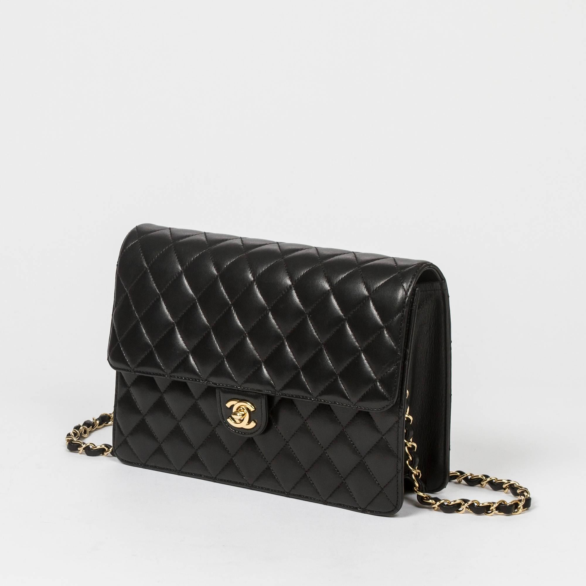 Mademoiselle Bag in black quilted lambskin with gold tone chain strap interlaced with black leather. Gold CC turnlock closure. Burgundy leather interior with one zip pocket. Gold tone heat stamps 