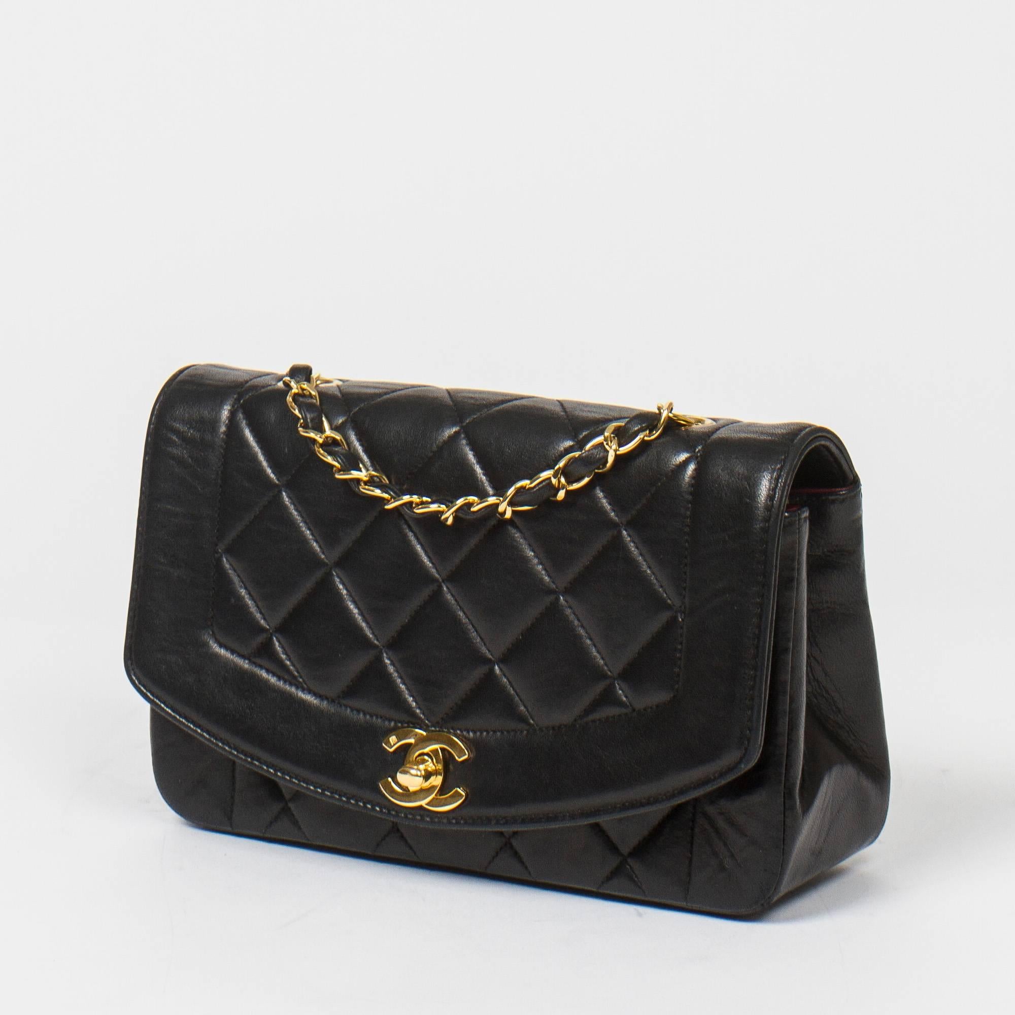 Vintage Mademoiselle Flap Bag in black quilted lambskin with gold tone chain strap interlaced with black leather. Gold tone CC turnlock. Burgundy leather interior with one slip pocket and one zip pocket. Gold tone heat stamps 