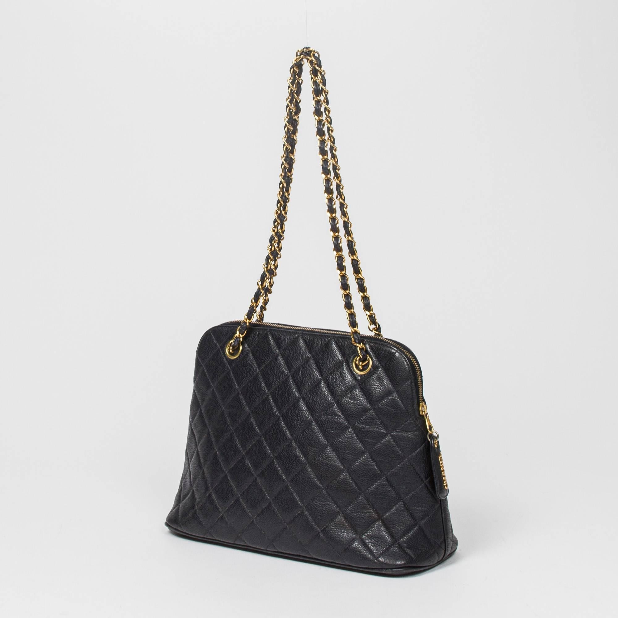Zip Shoulder Tote in Navy Blue Quilted leather with gold tone chain strap interlaced with blue leather. Zip closure with 