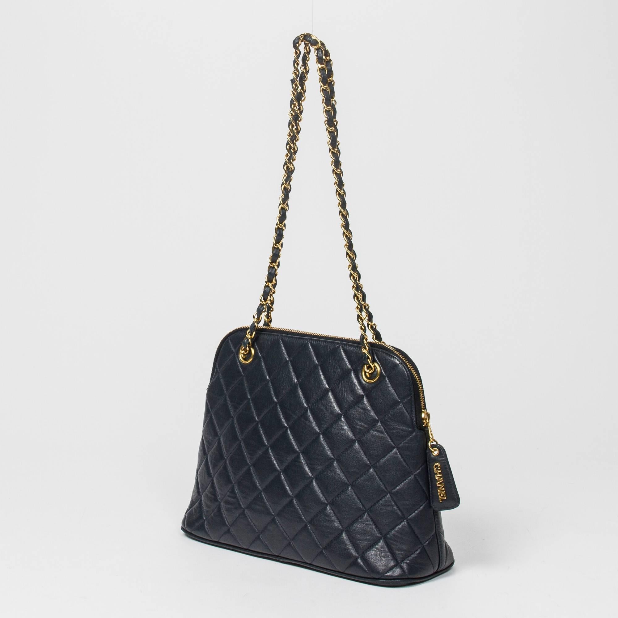Shoulder bag in Navy blue quilted leather with double chain strap interlaced with leather, gold tone hardware. Zip closure with 