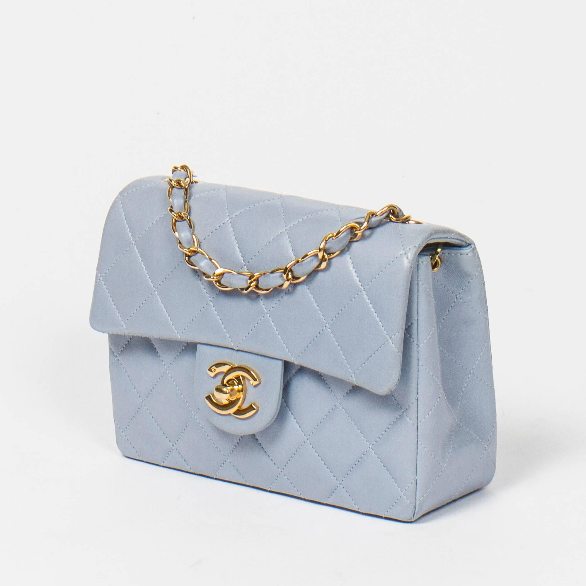Timeless Mini in Light blue leather with gold tone chain strap interlaced with blue leather. Turnlock 