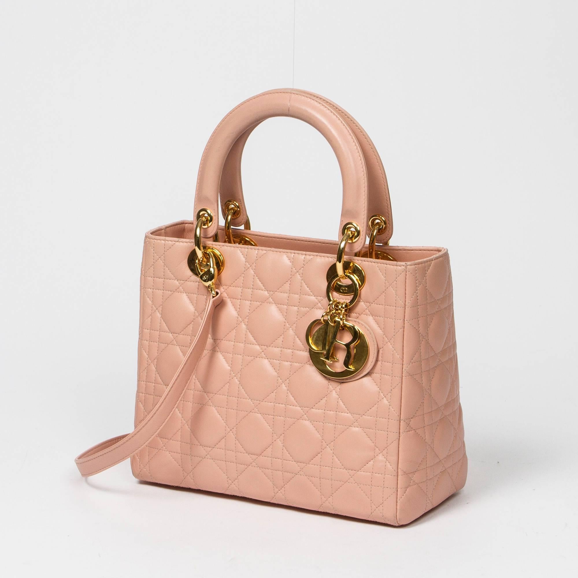 Lady Dior MM in soft pink cannage leather with optional shoulder strap, handles in soft pink leather. Gold hardware. Zip closure. 4 protective feet. Pink monogram fabric lined interior with one zip pocket. Shoulder strap, dustbag and box included.