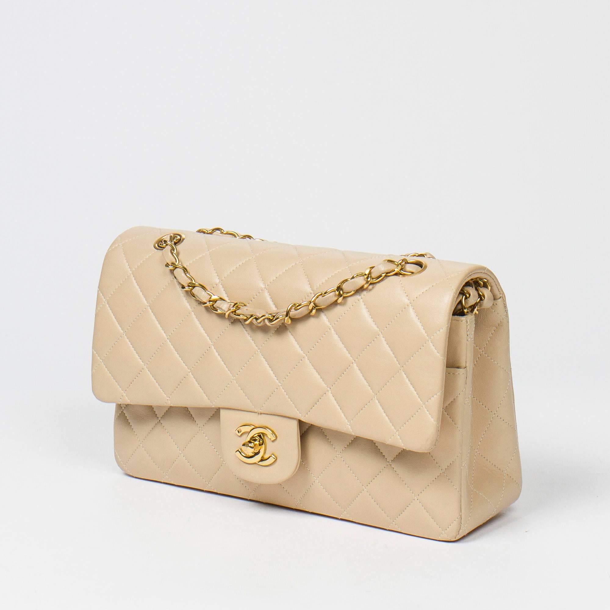 Classic Double Flap in beige quilted calf leather, double chain strap interlaced with leather, signature turnlock closure, gold tone hardware. Back slip pocket. Beige leather lined interior with 3 slip pockets. Gold tone heat stamp 