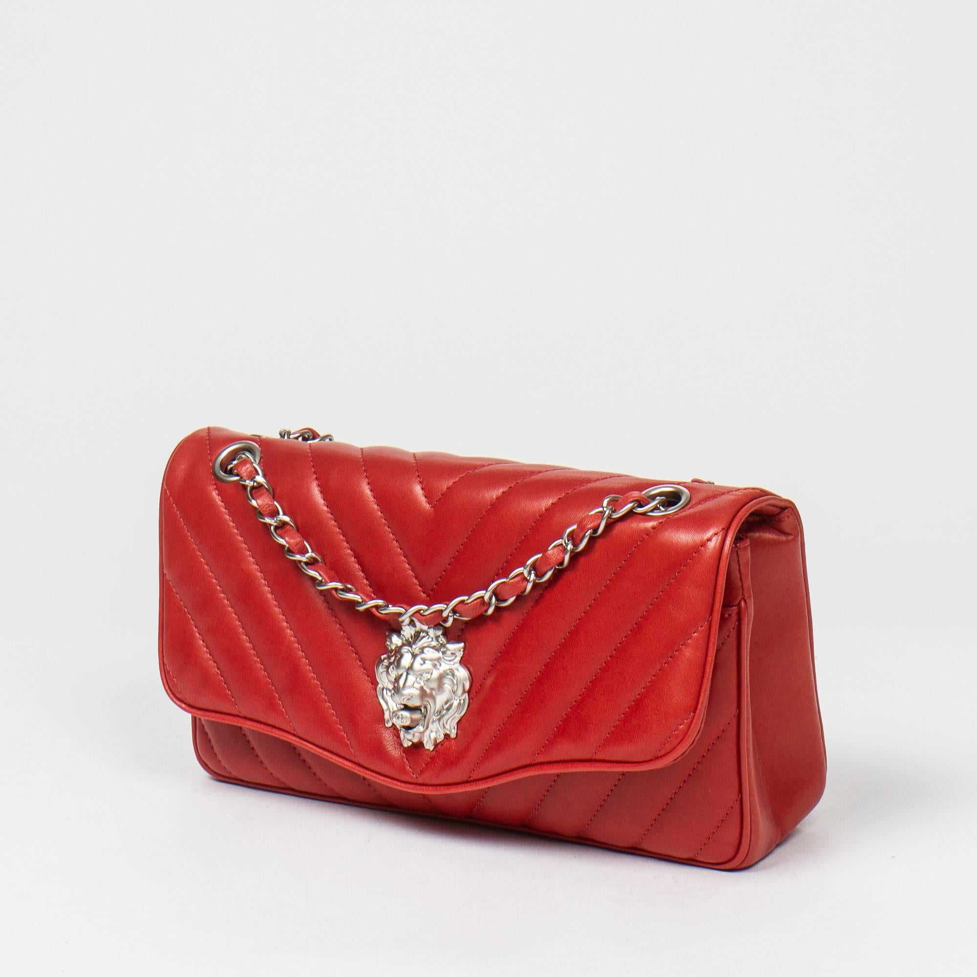 Classic Double Flap 26 in dark red quilted leather, double chain strap interlaced with leather, silver closure lion head shape, silver tone hardware. Back slip pocket. Red leather lined interior with 3 slip pockets. Silver tone heat stamp 