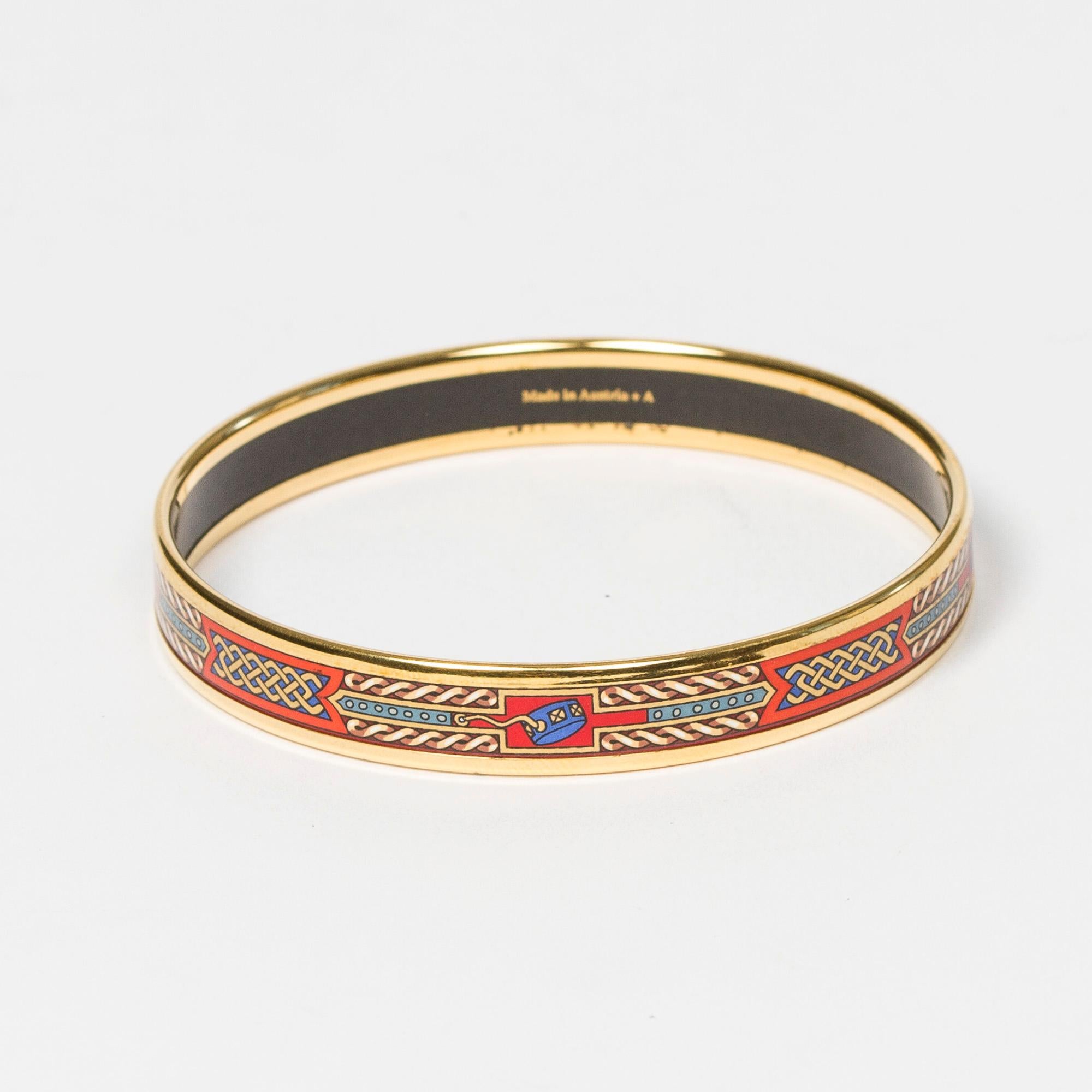 Costume Jewelry Enamel Bangle Hermes in Gold/Red/White The Production code is  and the product comes with a box. This product is rated condition : AB which means Gently Used : Regular wear signs, beautiful patina. May present scuffs or stains inside