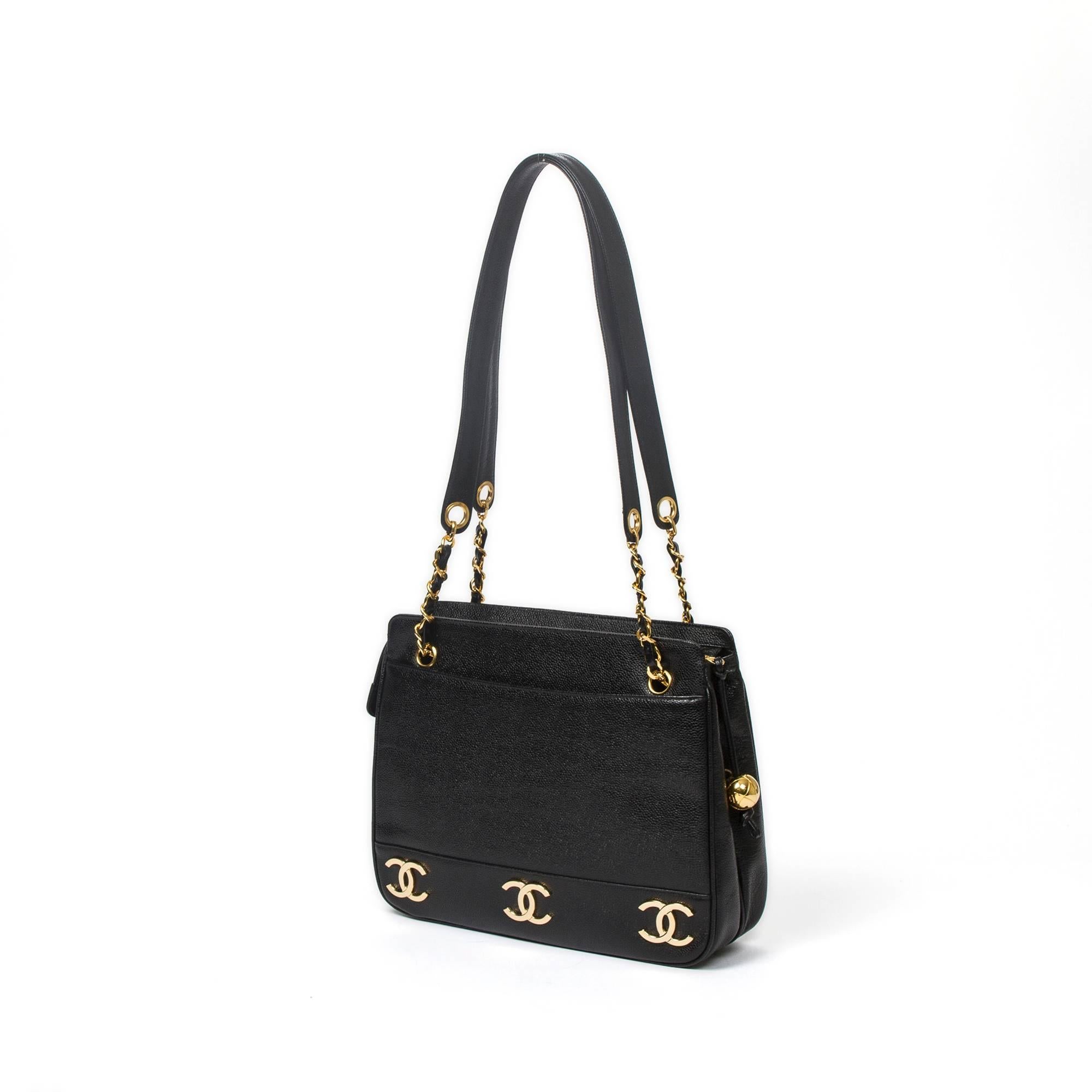 Chanel Vintage Tote bag 31cm in black	grained leather with chain and leather straps, gold tone hardware. Top zipper closure with gold tone sphere pendant zipper toggle. Black leather lined interior. Tag, authentication card, dustbag, box, booklet
