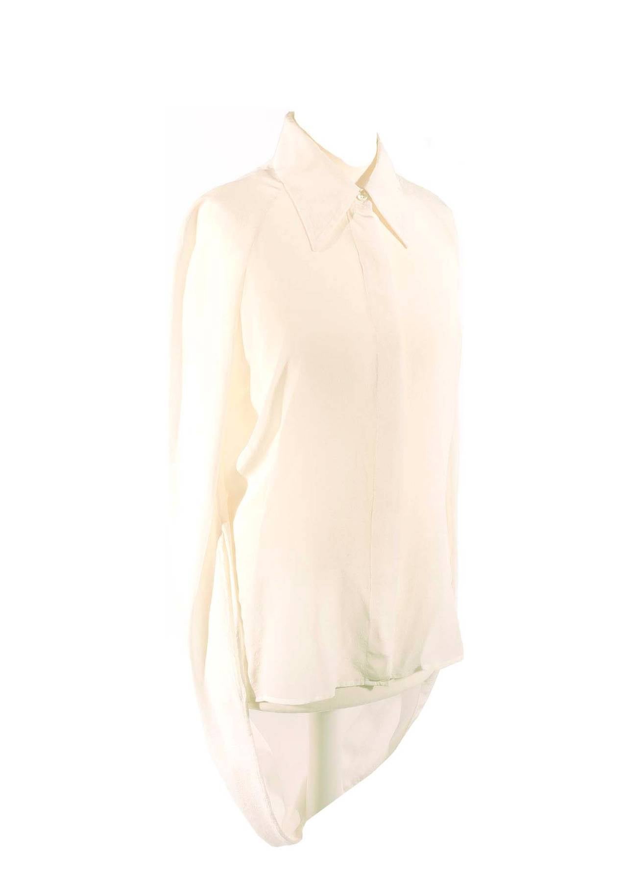 Maison Martin Margiela cream silk shirt with special sleeve details. Shirt has mother of pearl buttons, raglan sleeve, the sleeves are cut semi circle and have a drape detail in back. Iconic piece from Maison Martin Margiela Spring 2007. French size