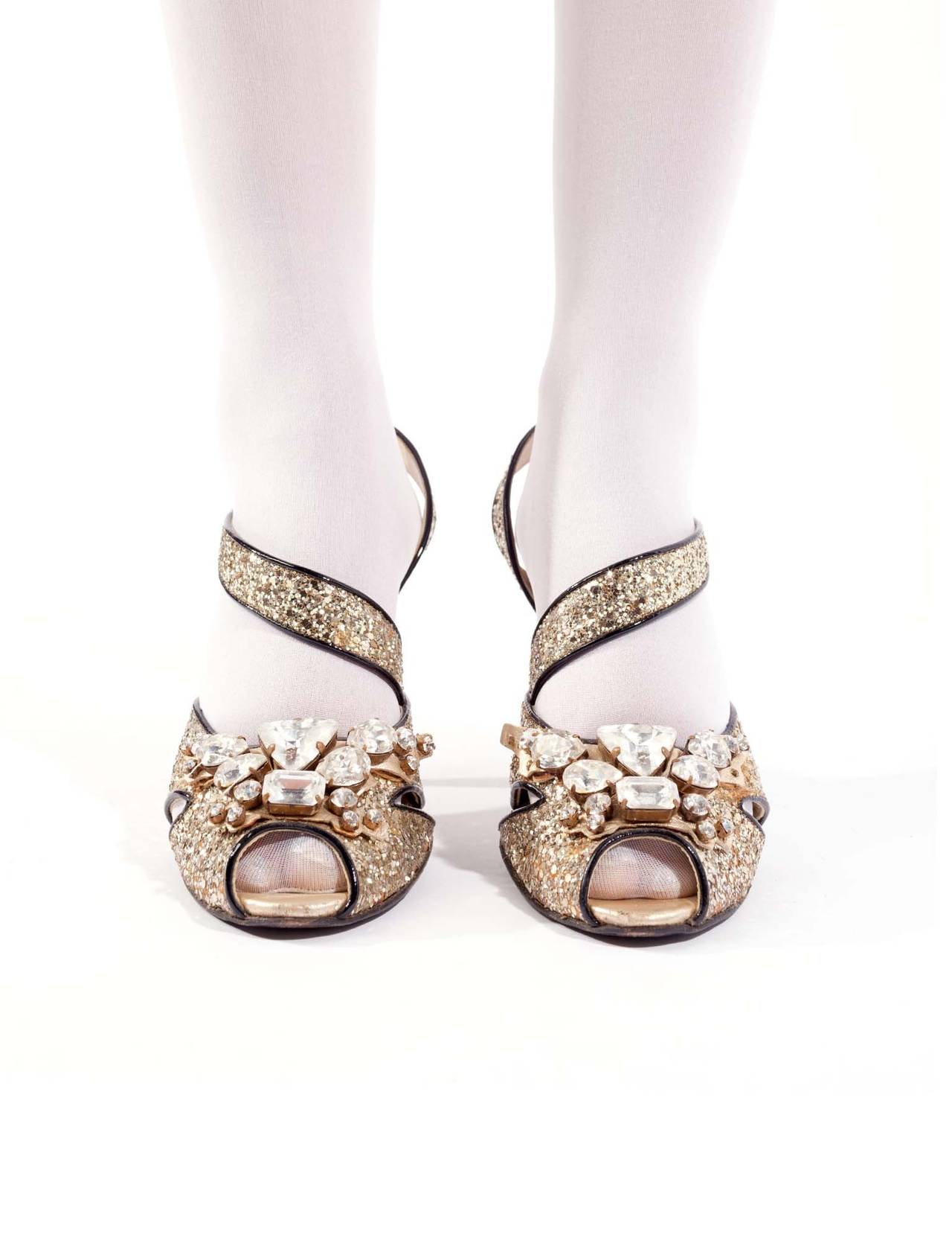 MIU MIU Silver glitter rhinestone heels. Heels are slingback with black patent leather piping detail. adjustable sling back straps. Multi-stone embellished fronts with clear, silver set rhinestones, and cubic zirconia trim. Some stones are missing,